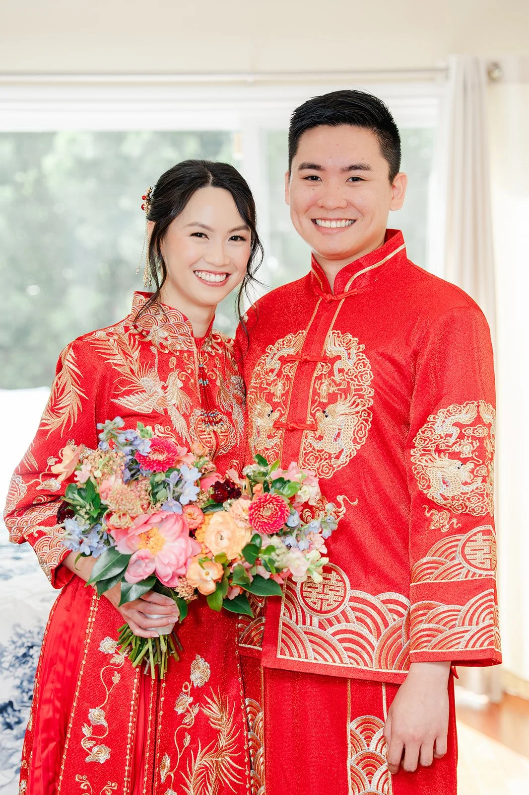 The couple holding the bouquet together.