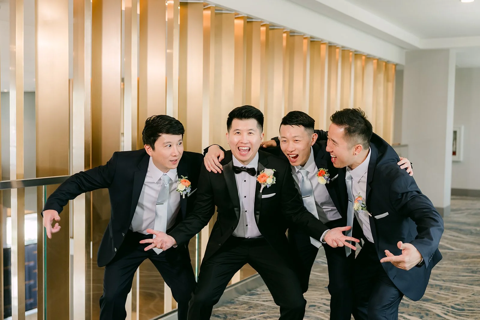 San and his groomsmen striking a playful pose together.