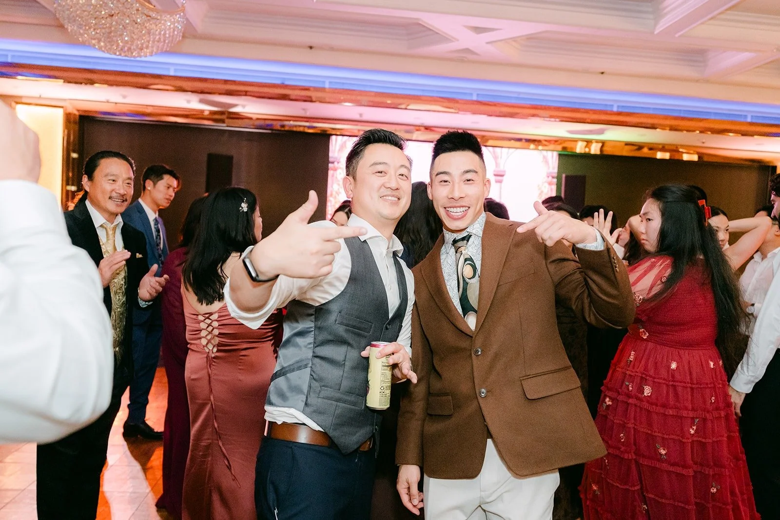 Groomsmen and friends dance with the couple