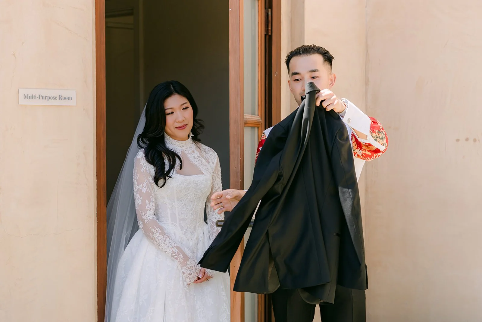 Kim and Vincent on either side of the bridal suite door for their first touch