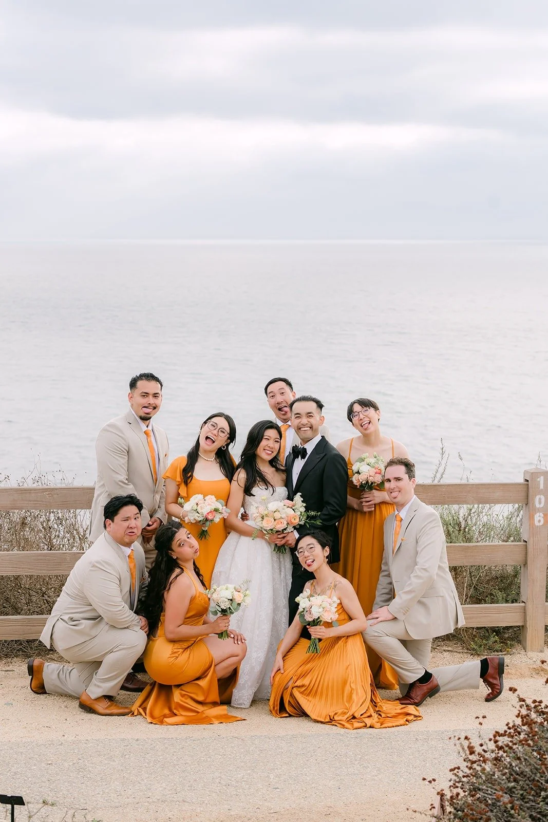 Wedding party lounging on the bluff for a playful group shot