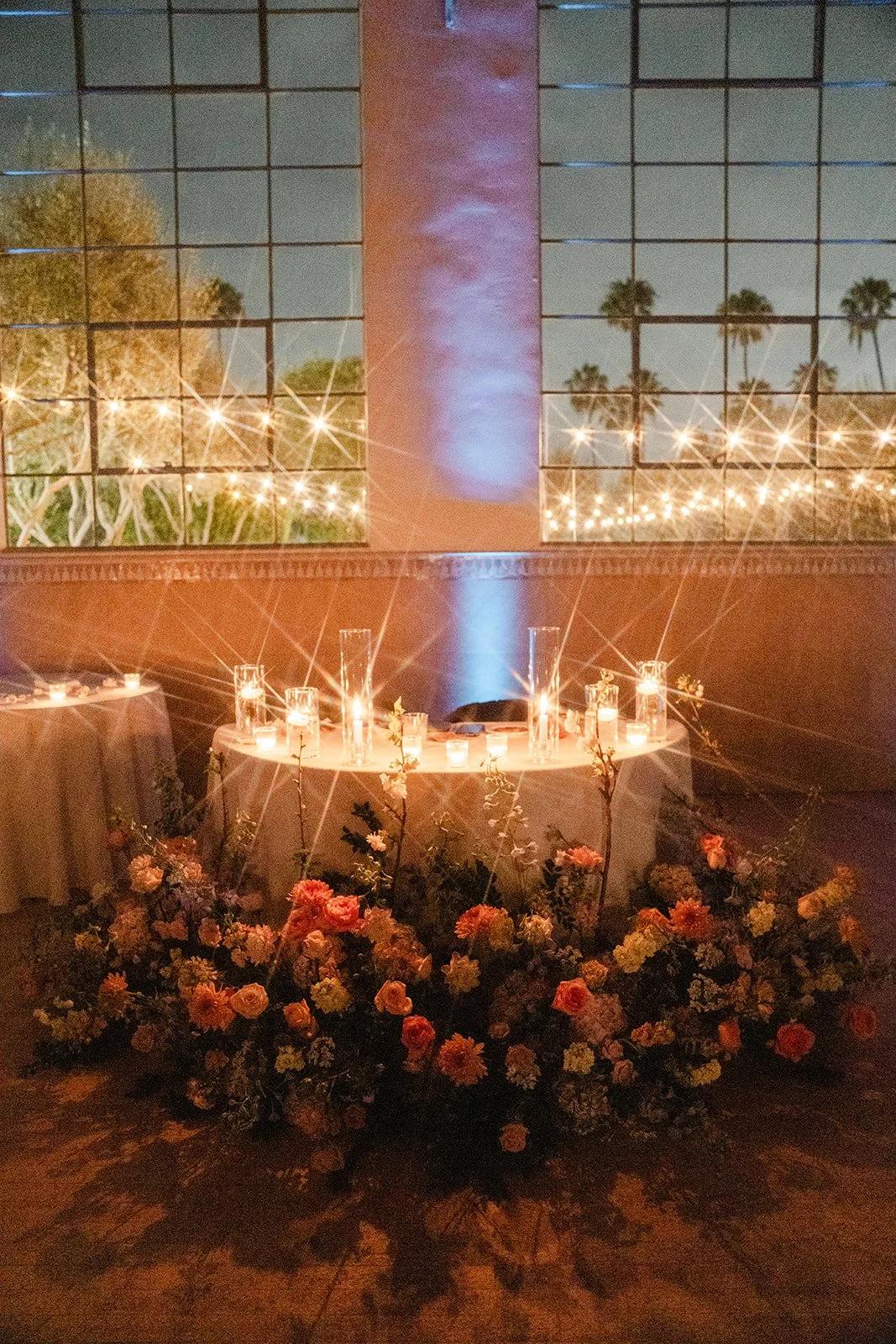 Sweetheart table glowing with candles at night