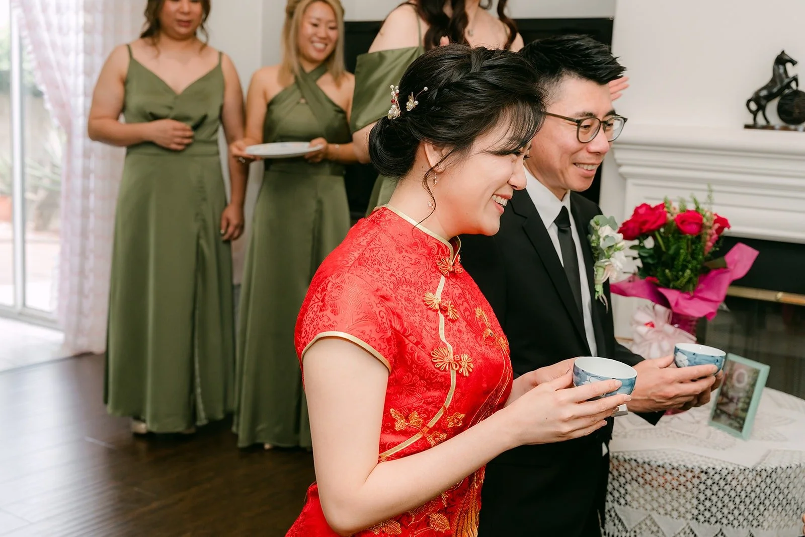 Eunice and Eric holding teacups, ready to begin their Chinese tea ceremony