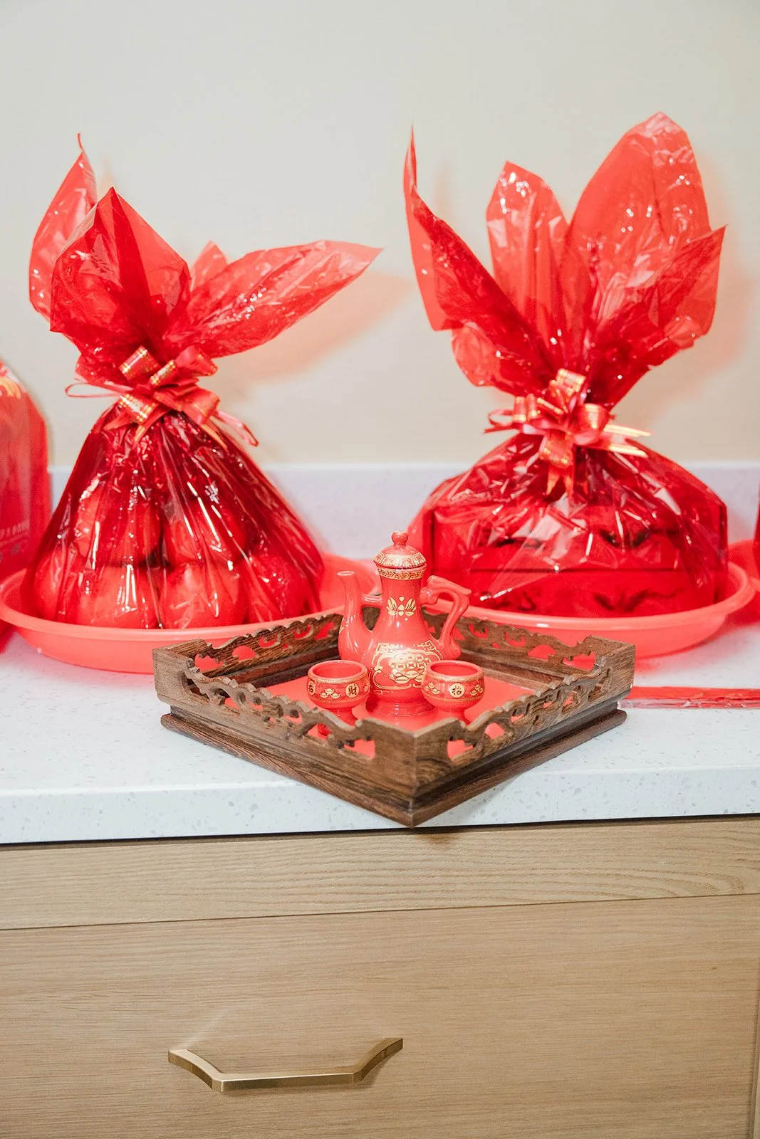 Red wrapped gift baskets on the table.