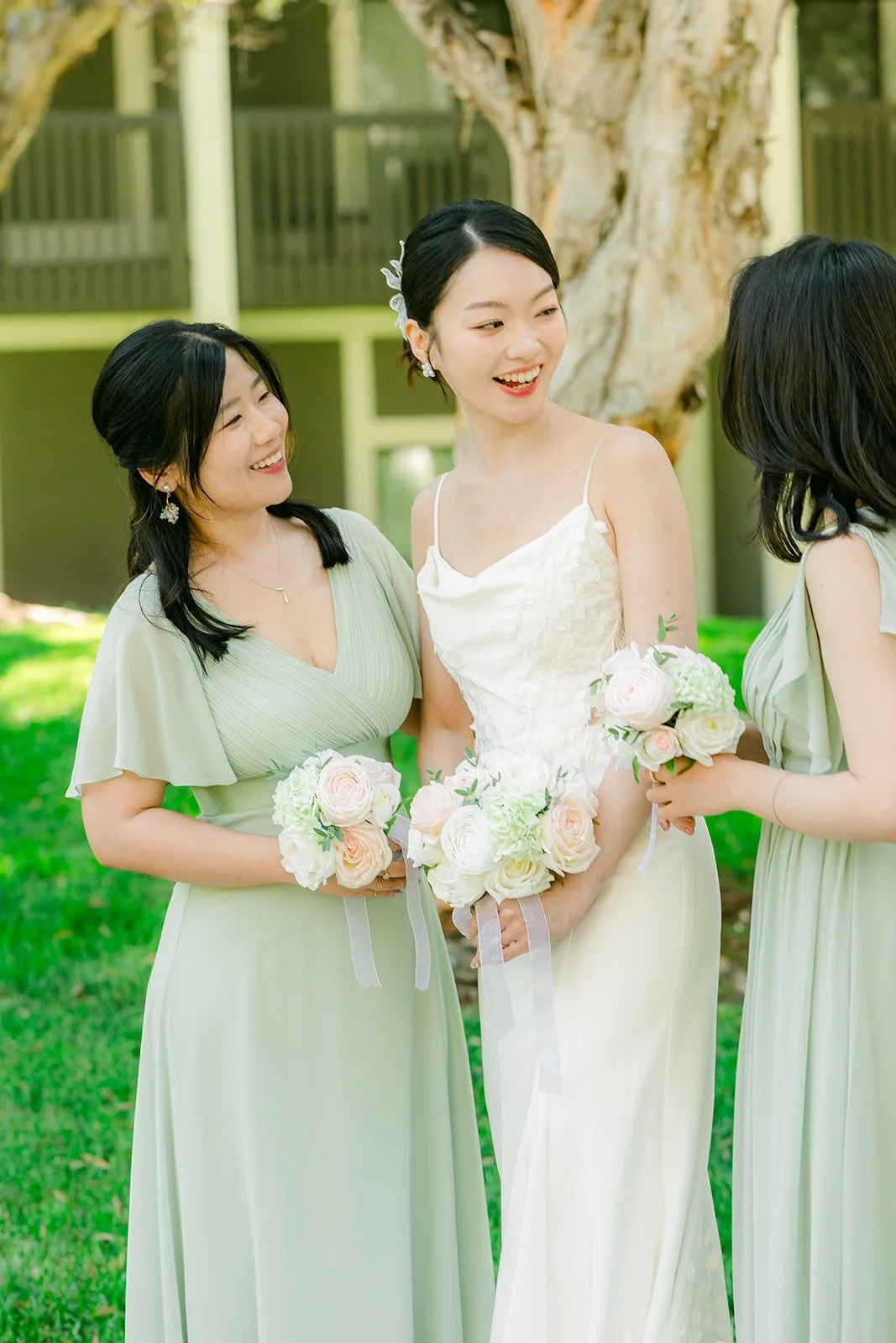 Tin laughing with two bridesmaids