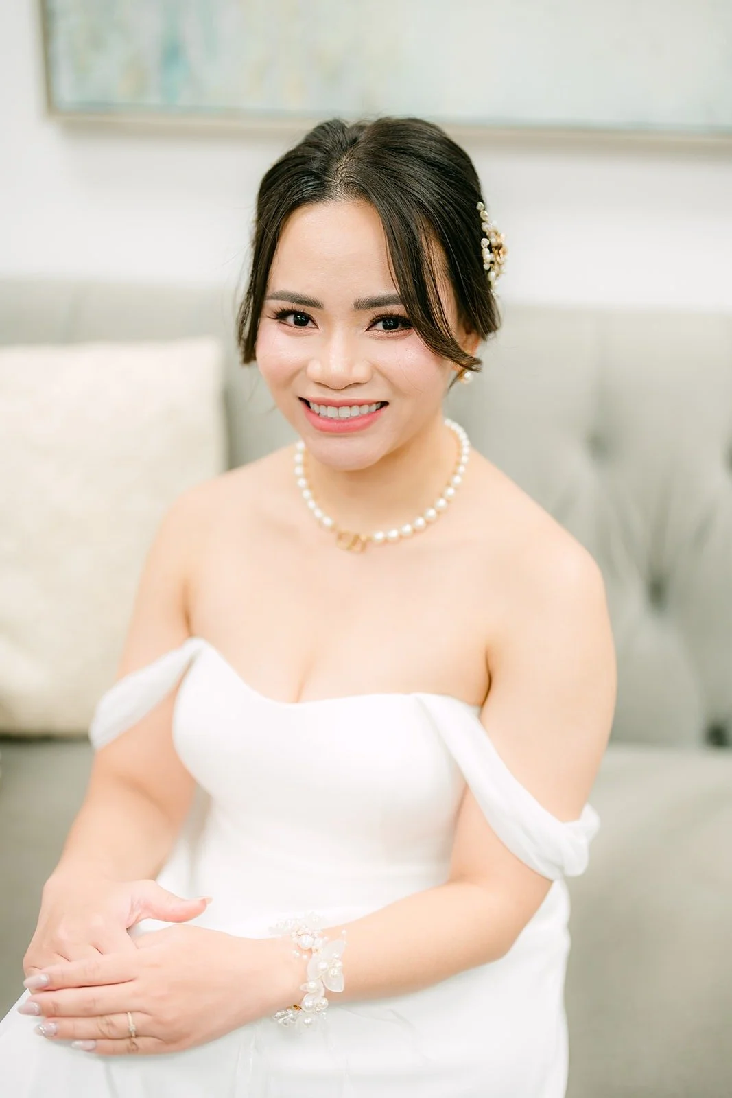 Ivy in her off the shoulder gown and pearl necklace