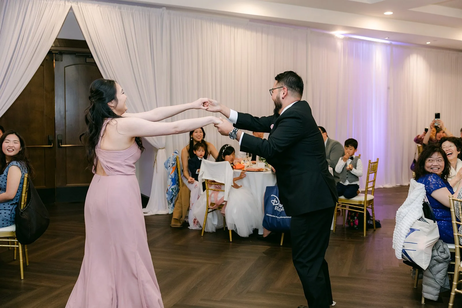 Bridesmaid and groomsman dancing into the reception for the grand entrance