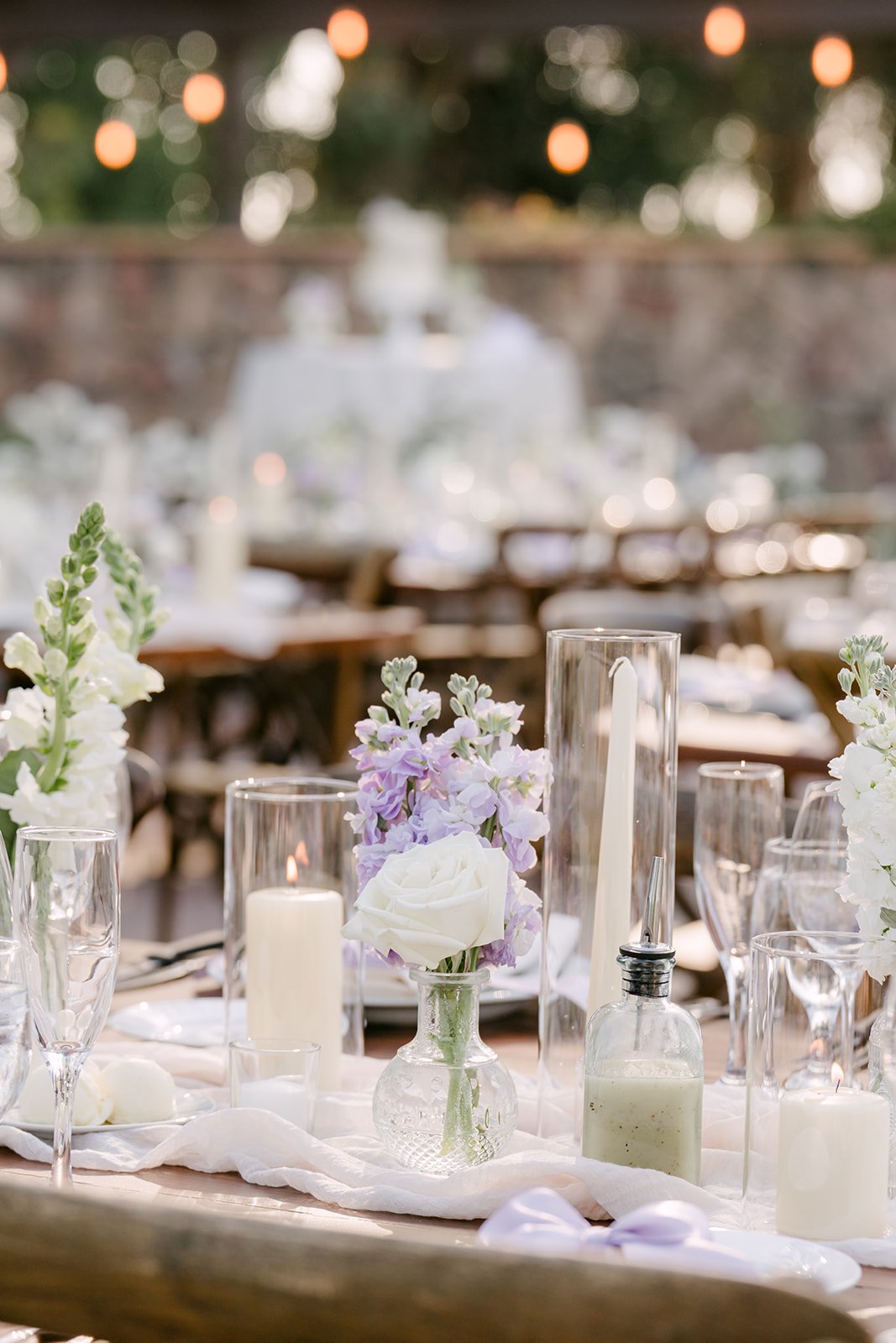 Candlelit table setting with white and lavender florals