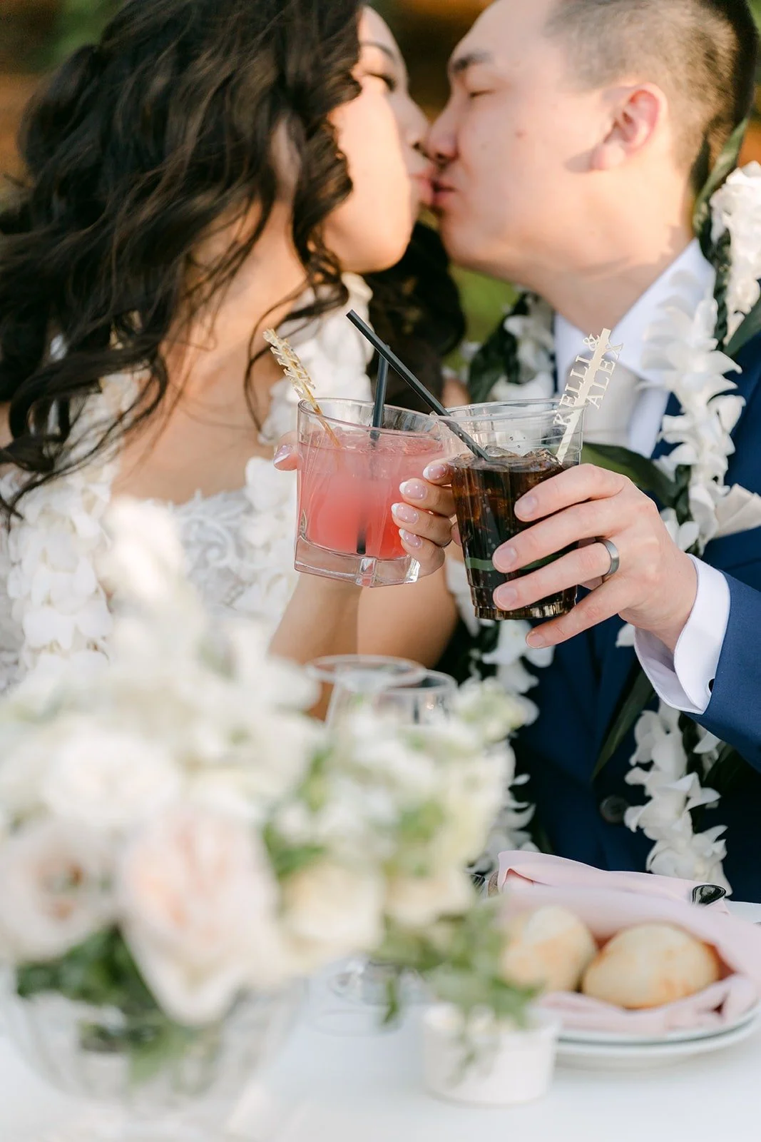 Kelli and Alex kissing as they sip their signature cocktails, photographed by One and Only Production