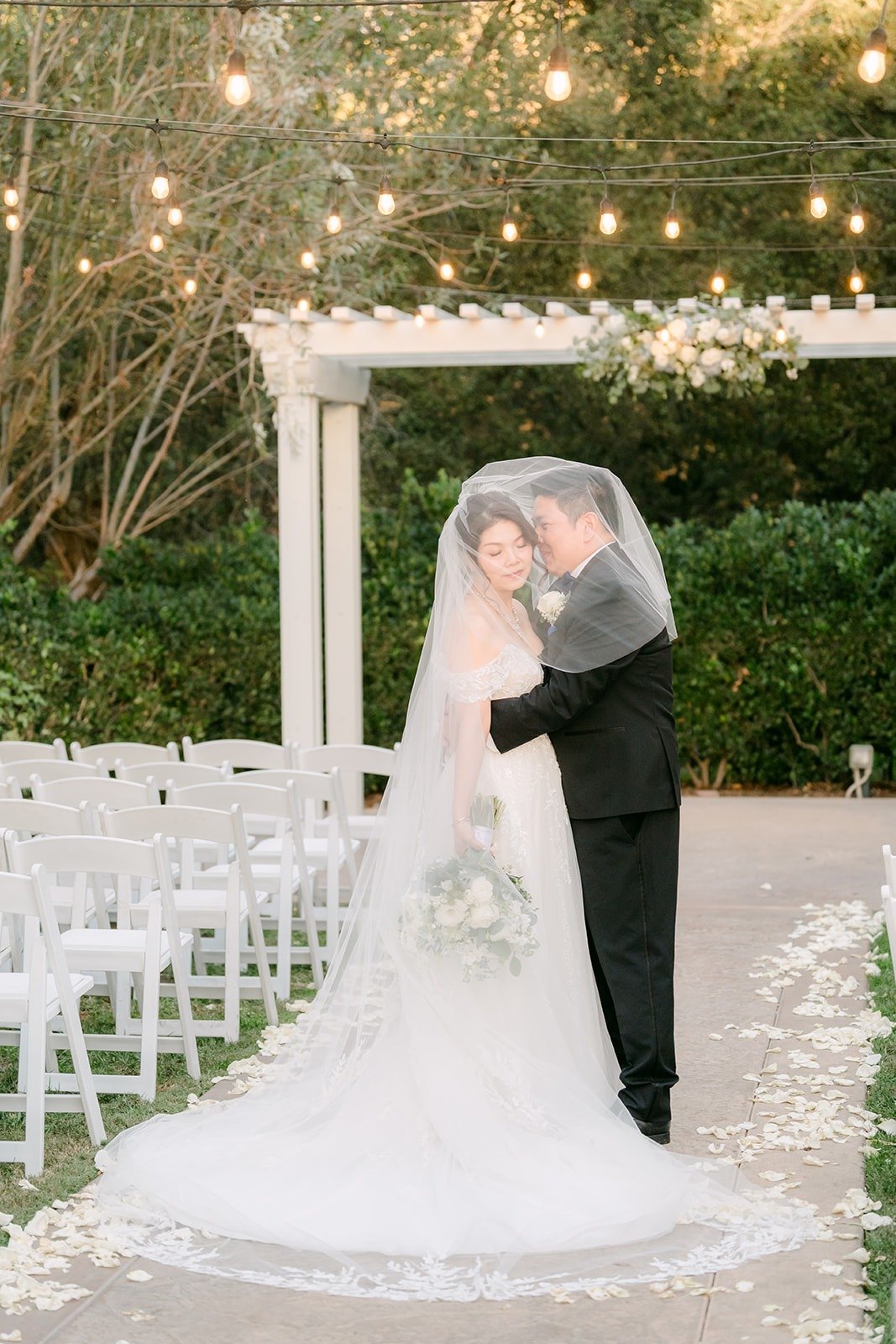Sochi and Jay under her veil at golden hour