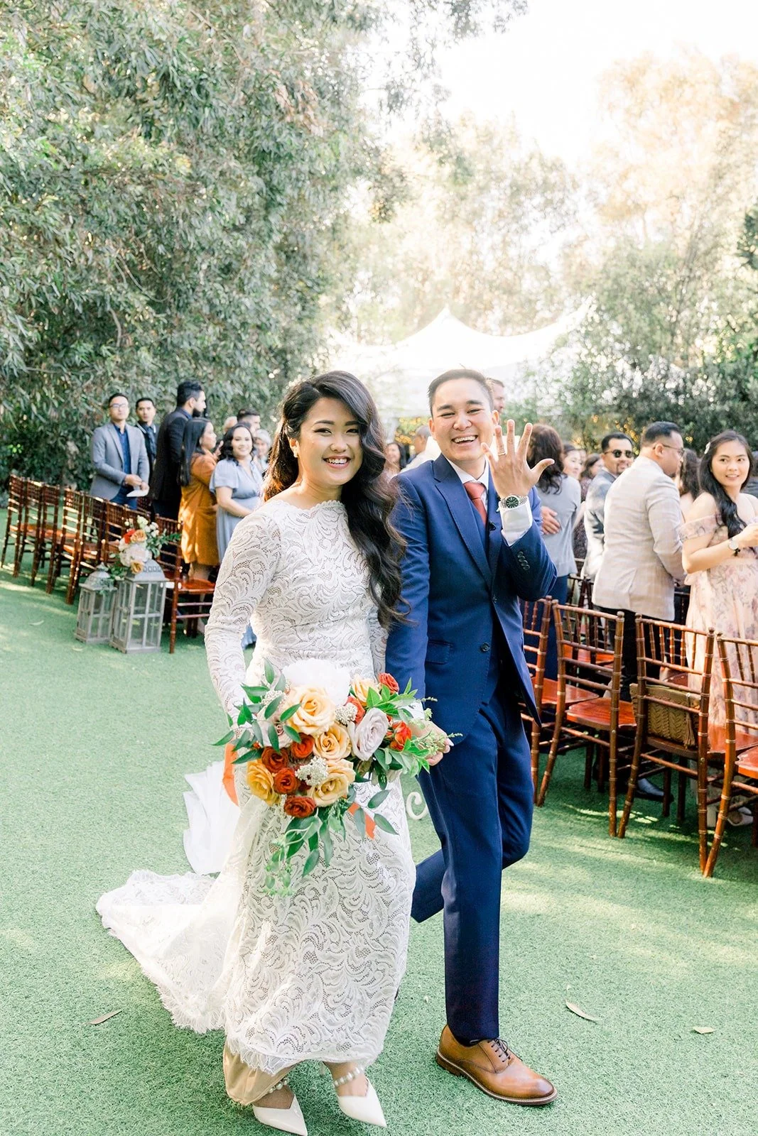 Hannah and Vincent walking back up the aisle as newlyweds