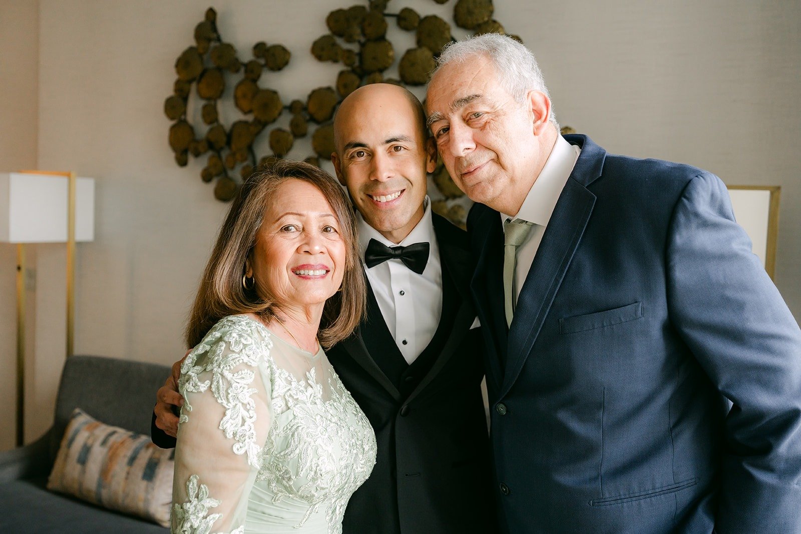 Daniel smiles with two family members before putting on his jacket