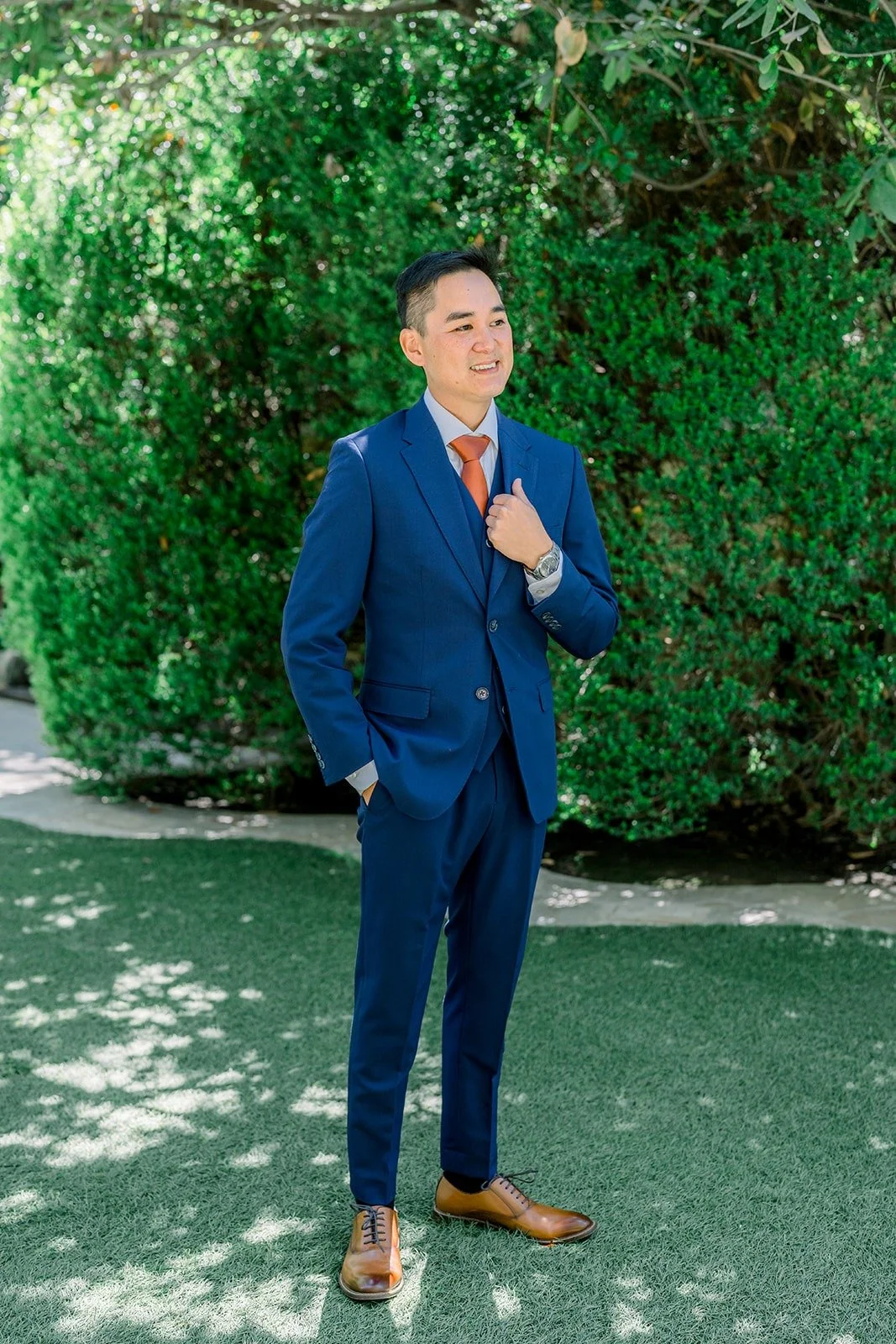 Full length portrait of Vincent in navy on the lawn