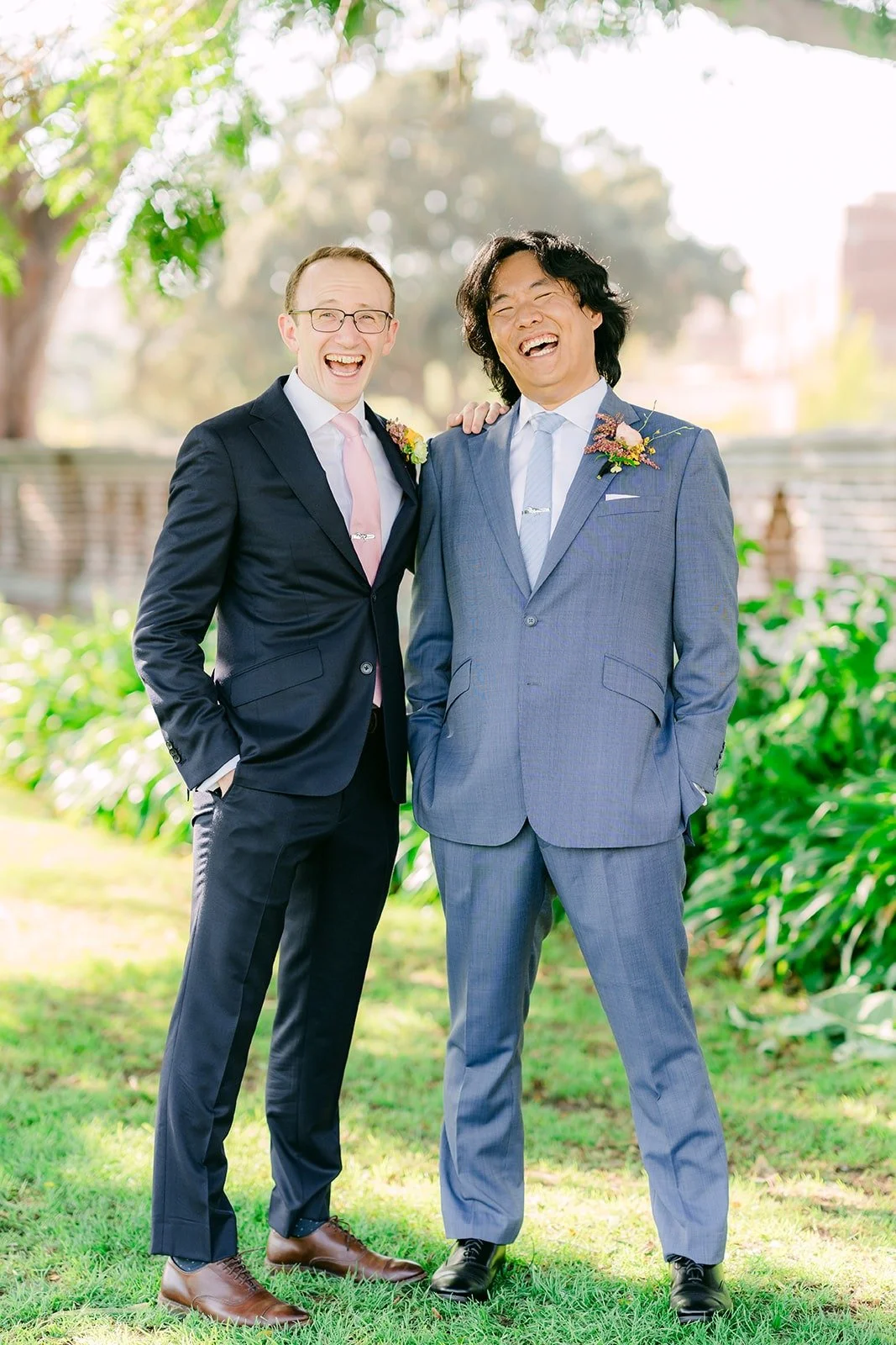 Philip laughing with a groomsman in the Rose Garden