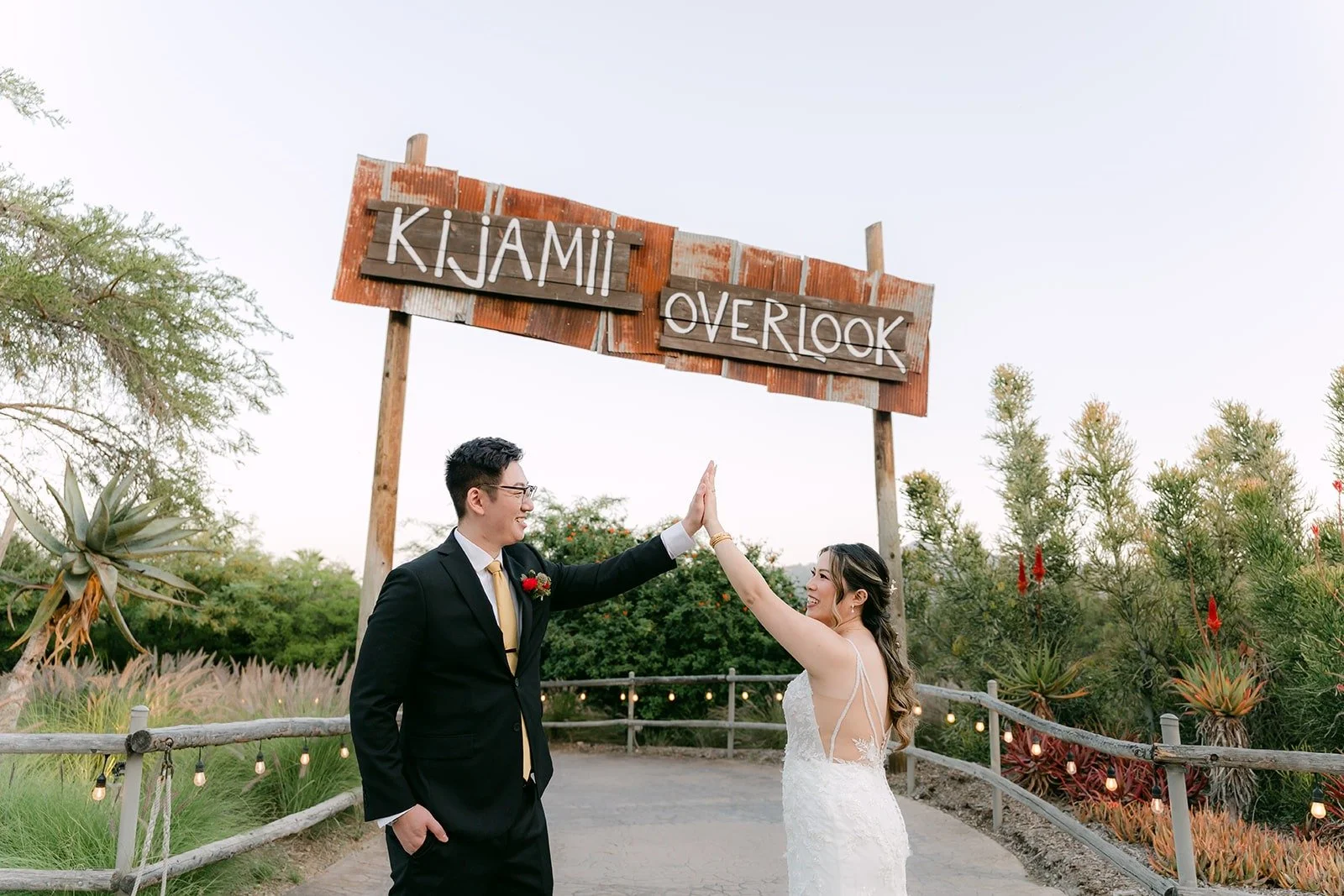 Joanne and Zach cheering under the Kijamii Overlook sign