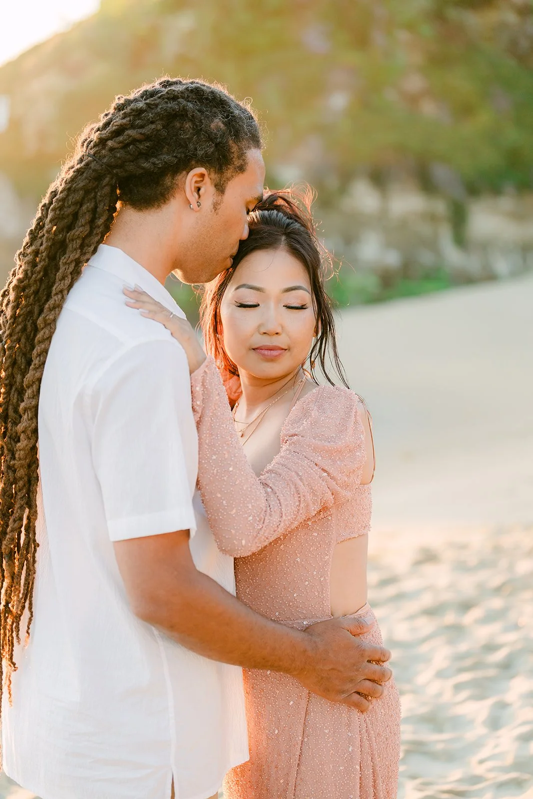 Michael holding Amy close on the beach.