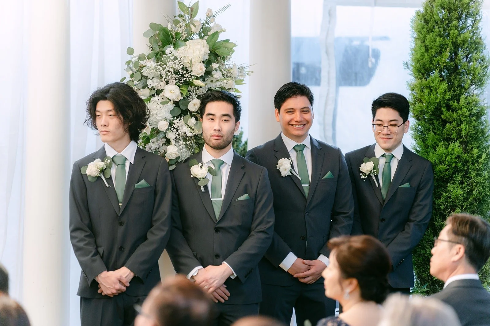 Groomsmen watching the ceremony from the front