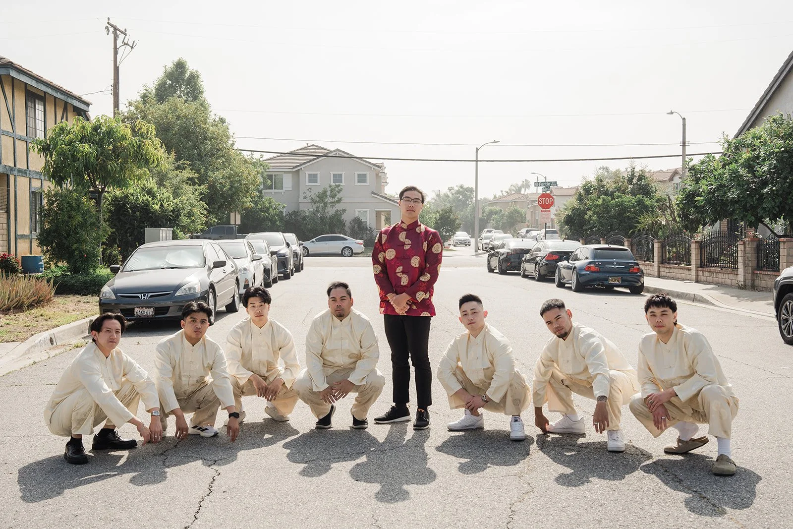 The groomsmen crouching around Danny.
