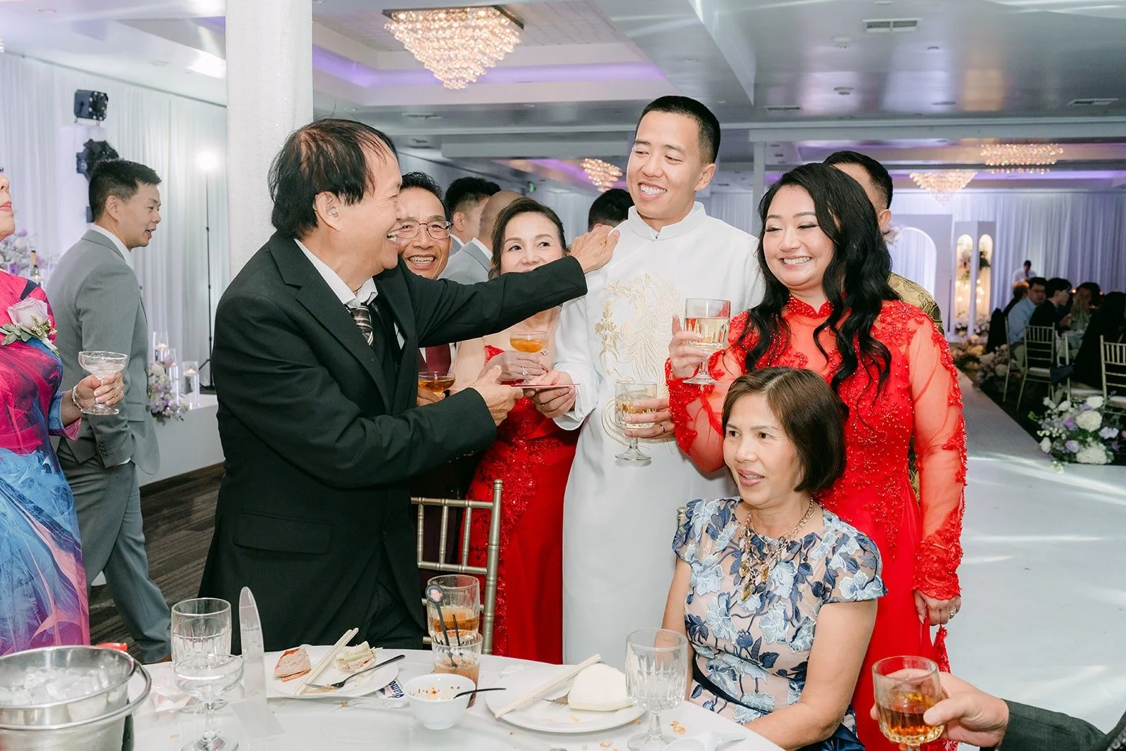 Jennifer and Kevin toast with guests during table greetings