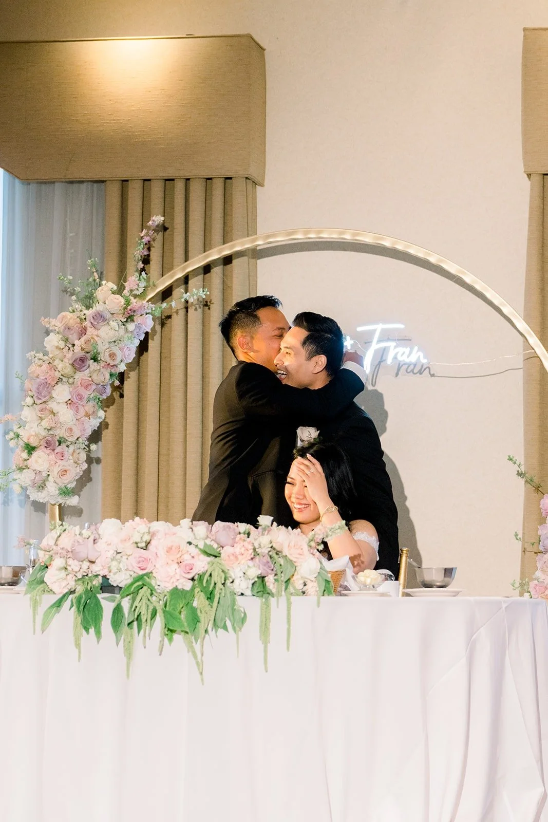 Francesca and Ralph sharing a kiss at the sweetheart table