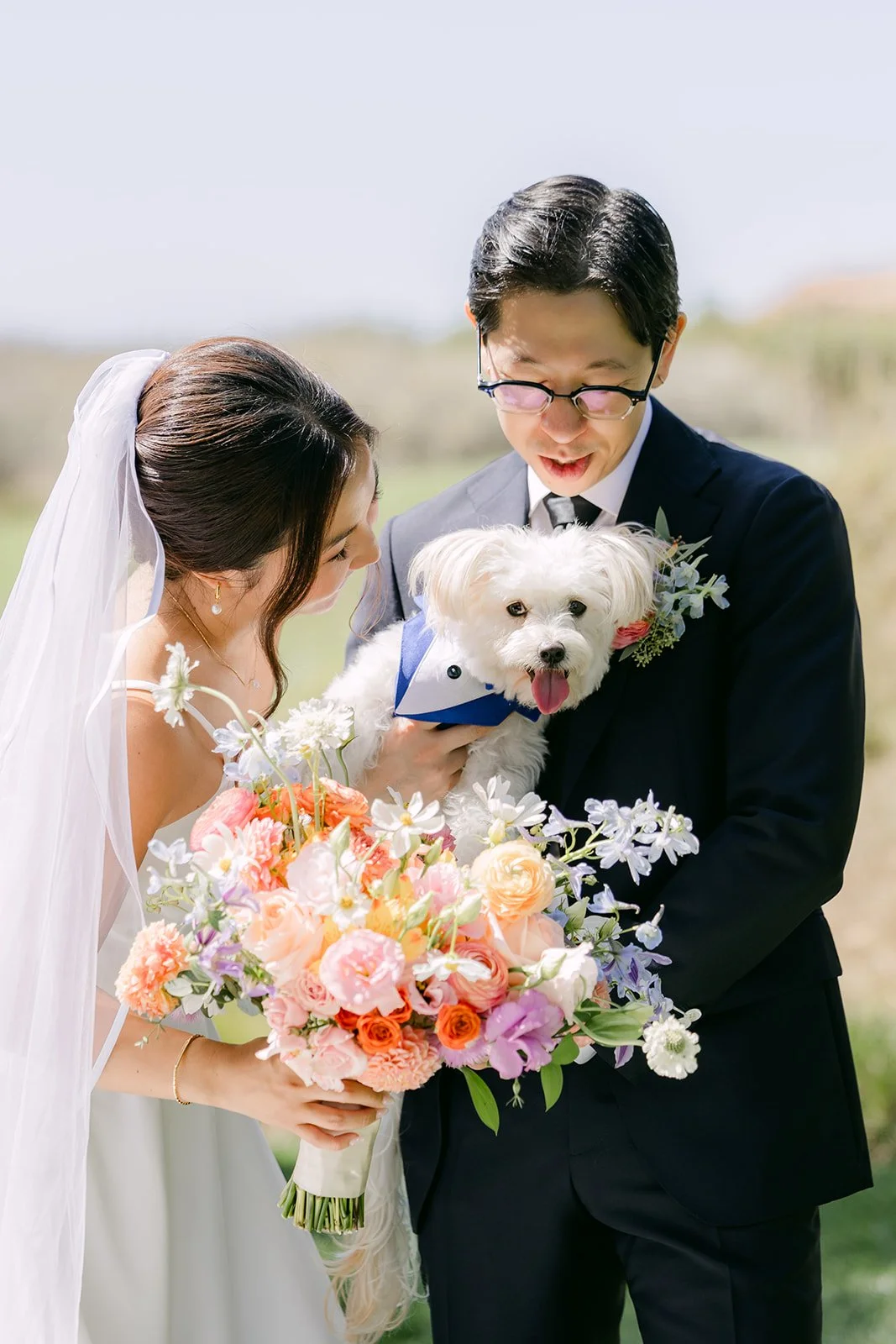 A family portrait with the pup tucked between them