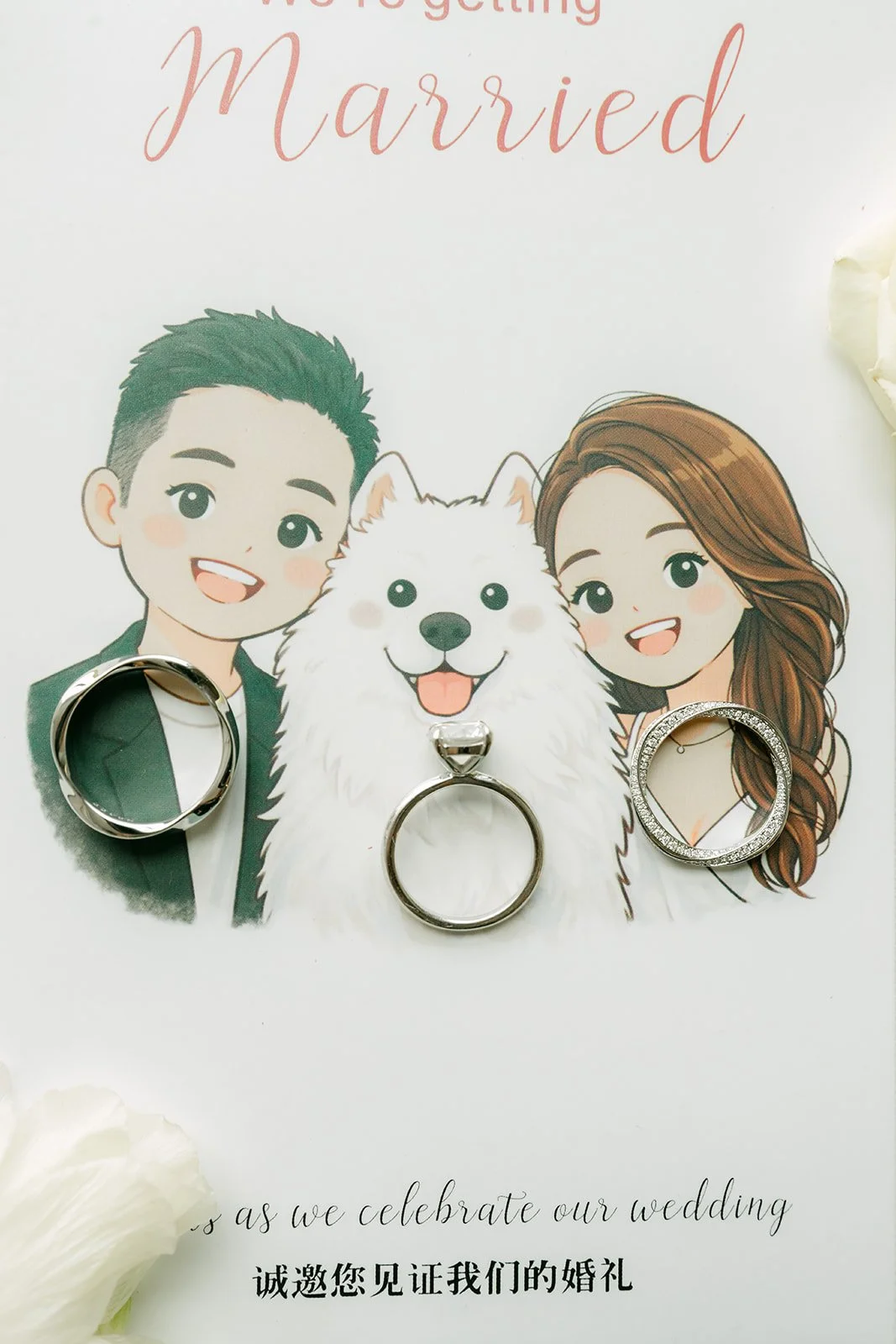 Jenny and Ryan's illustrated wedding invitation with a cartoon of the couple and their dog Snowball, with their rings.