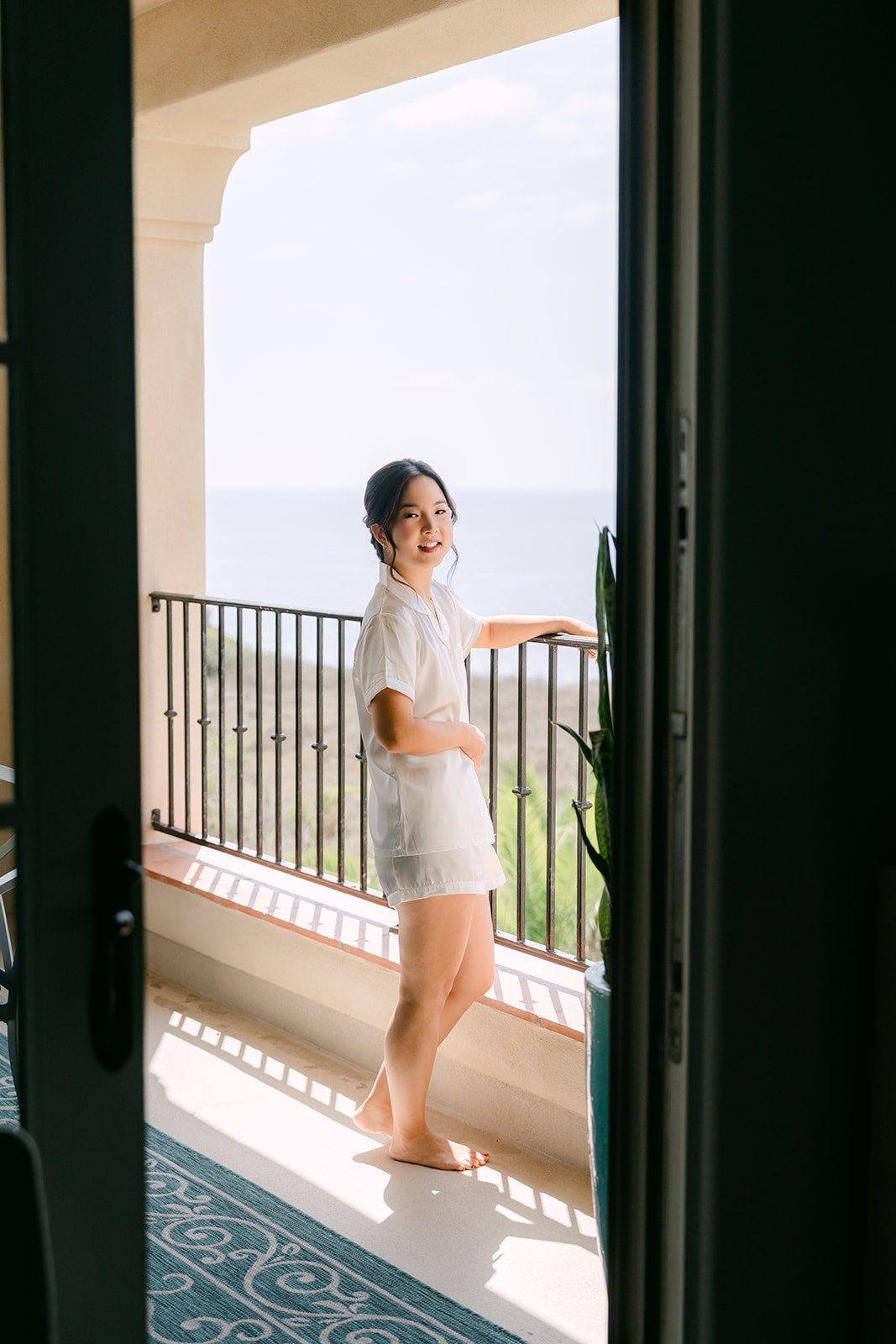 Saya in the balcony doorway in the morning light