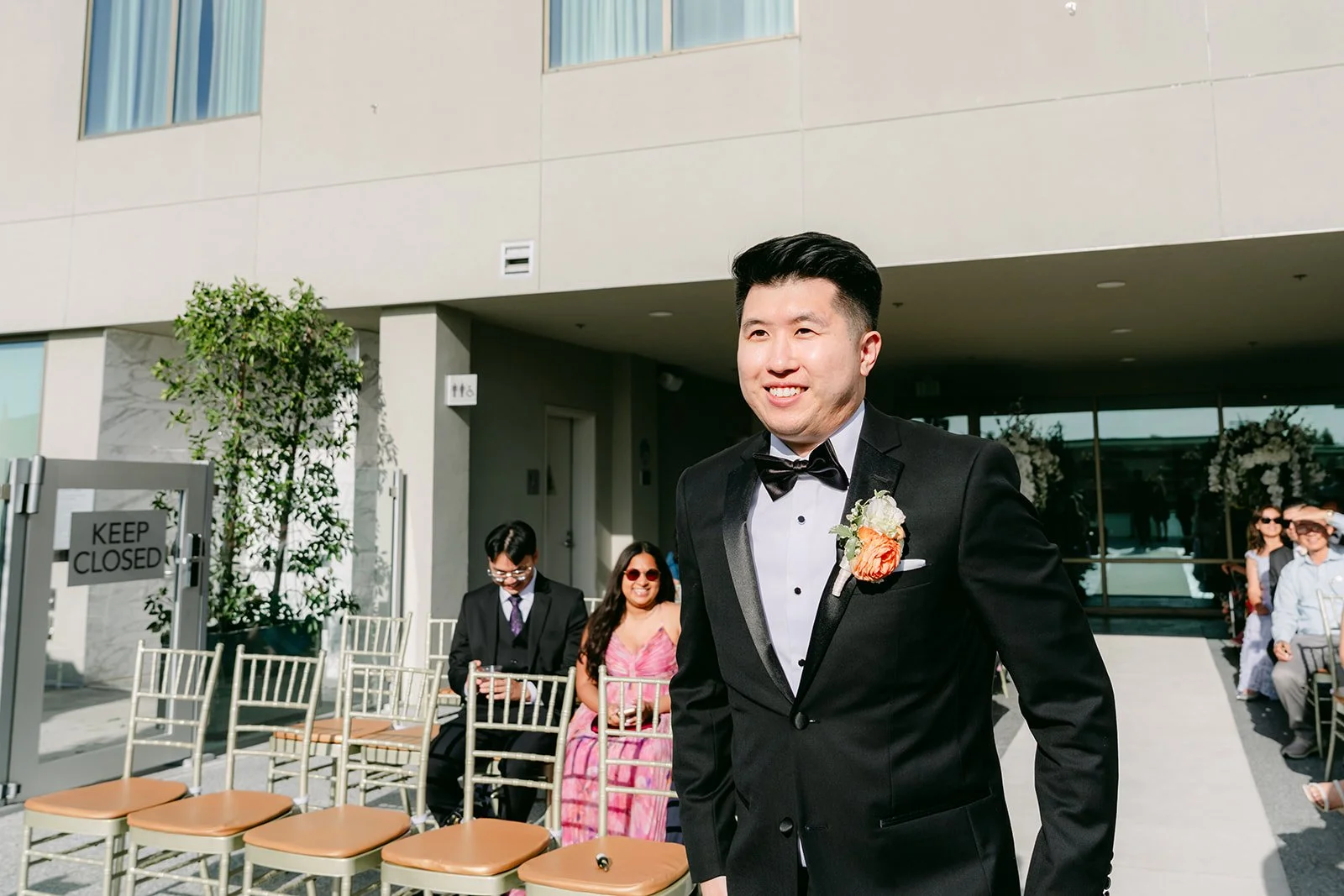 San waiting at the front of the ceremony.