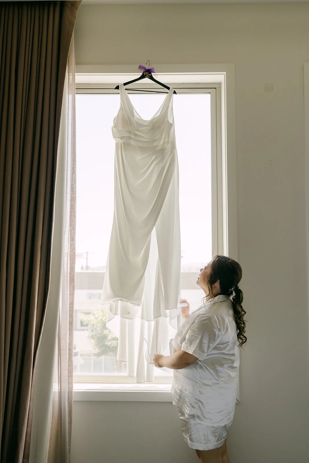 Mai's gown hanging in the window of the bridal suite at the Sheraton.