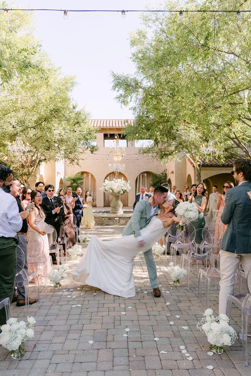 Groom dipping the bride for a kiss as they head back up the aisle