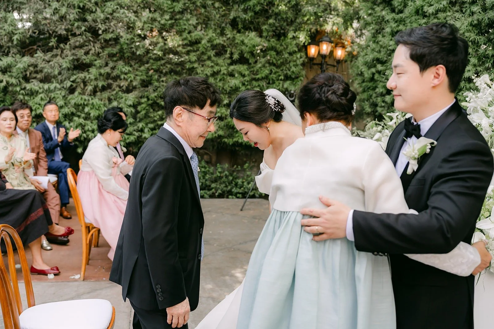 A family member in hanbok hugging Chorok during the ceremony