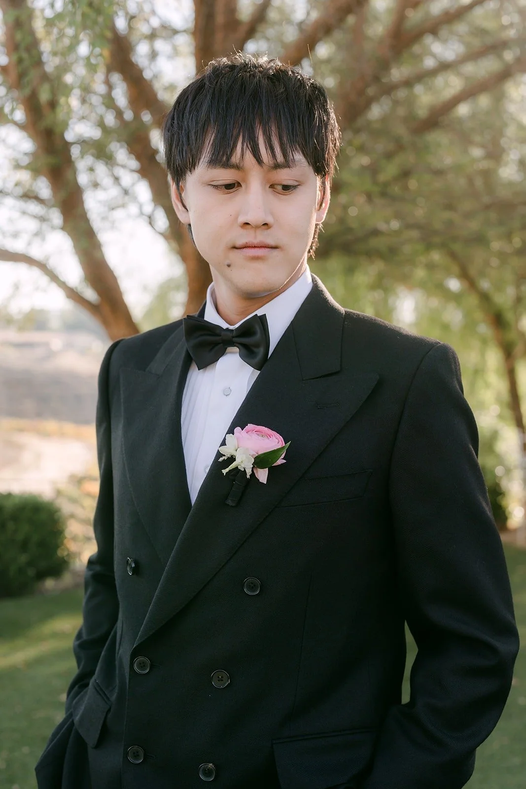 Job in his tuxedo with a blush boutonniere