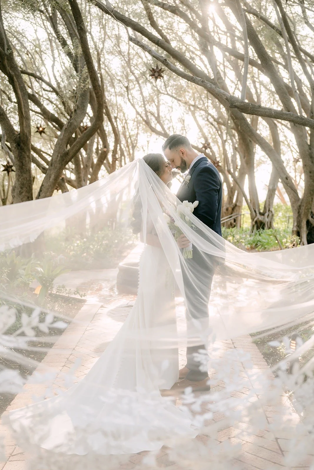 Mariana's long veil sweeping across the path as Danny holds her close
