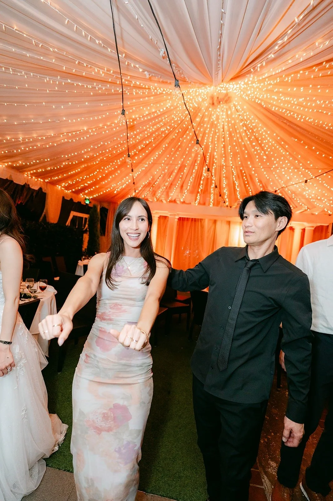 Valerie and a guest dancing under the string lights