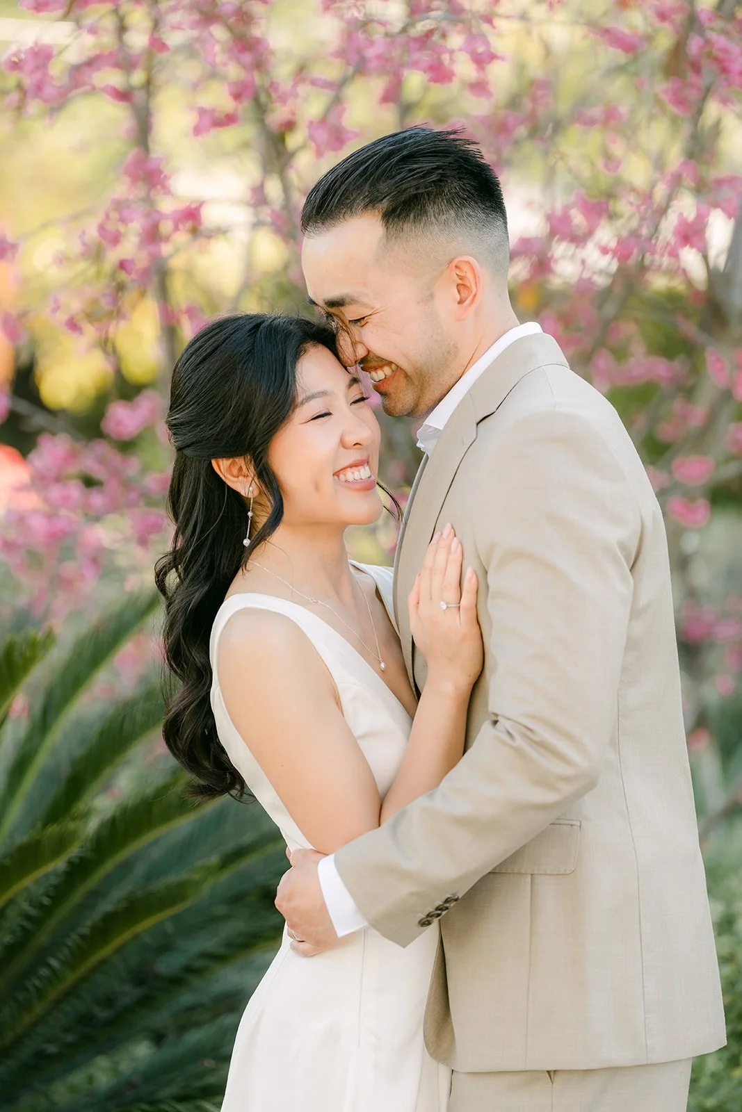 Kim smiling with her eyes closed as Vincent holds her close.