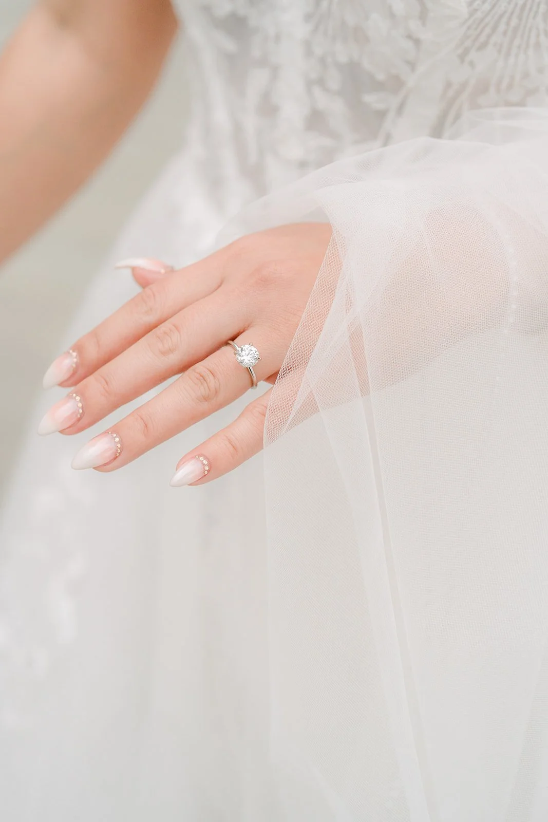 Close up of Raine's engagement ring on her veil