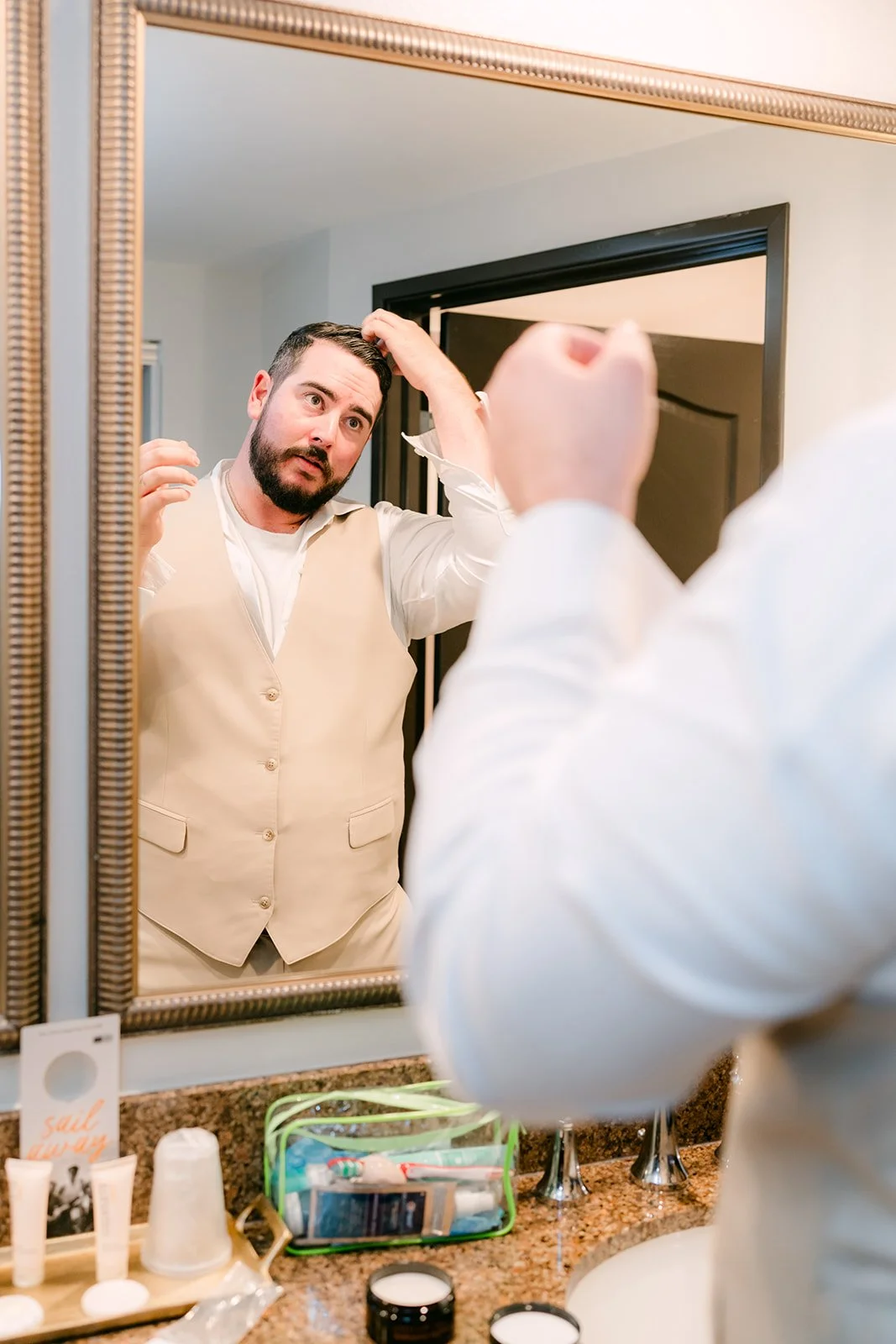 Cody fixing his hair in the mirror.