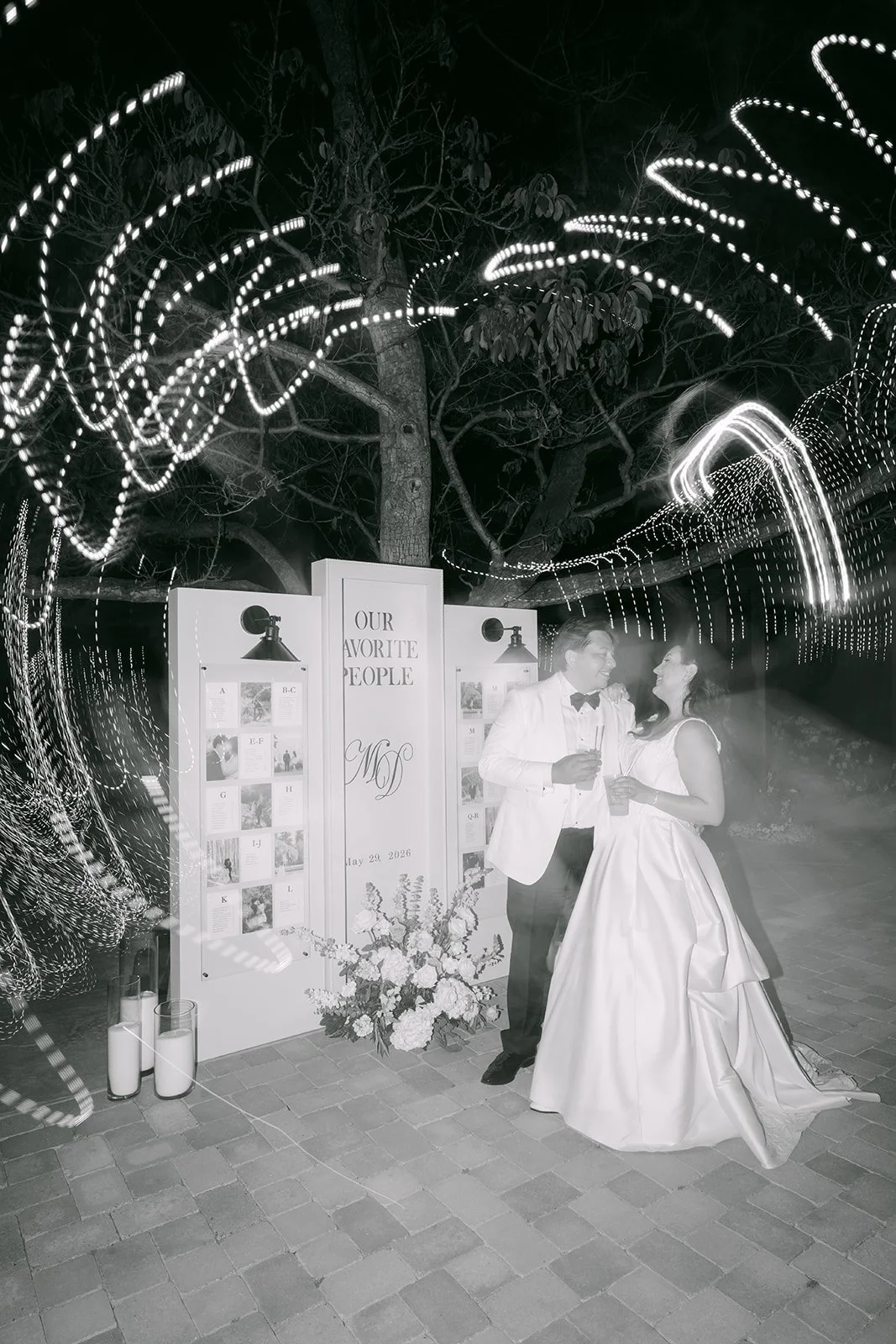 Black and white photo of the couple by the seating display at night