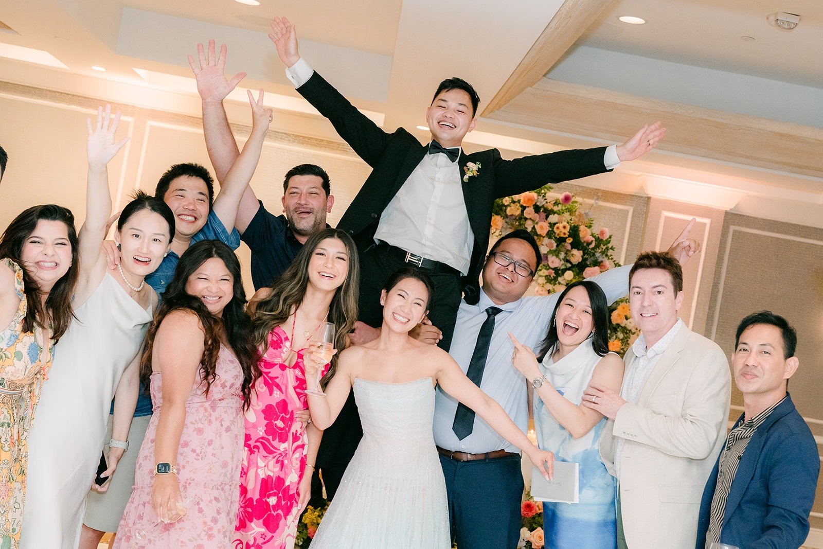 Friends jumping and cheering around Kylie and Mario during table greetings