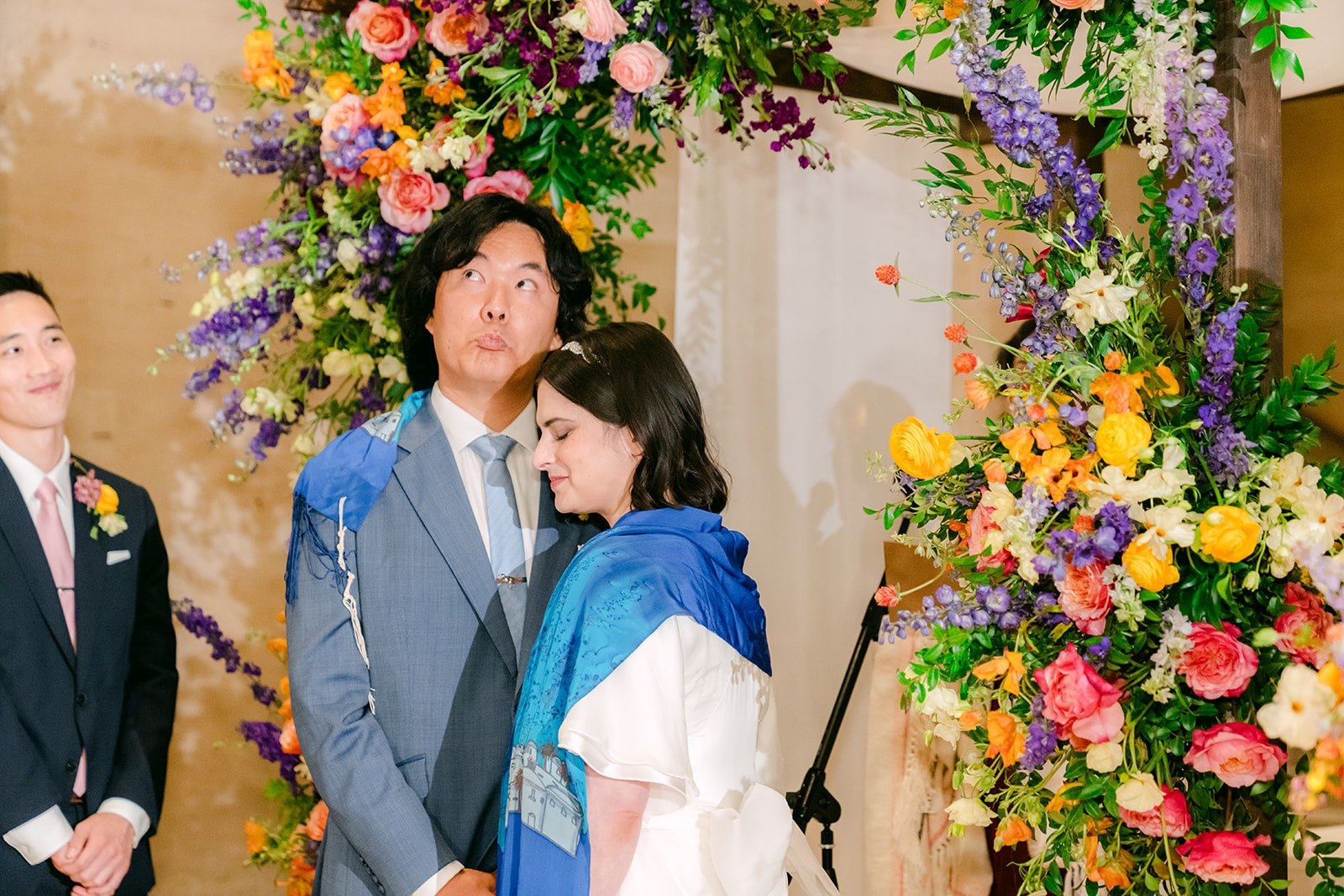 Jessie and Philip with the cantor at the floral arch