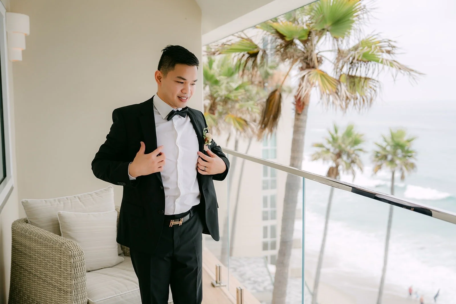 Mario buttoning his tuxedo jacket by the balcony