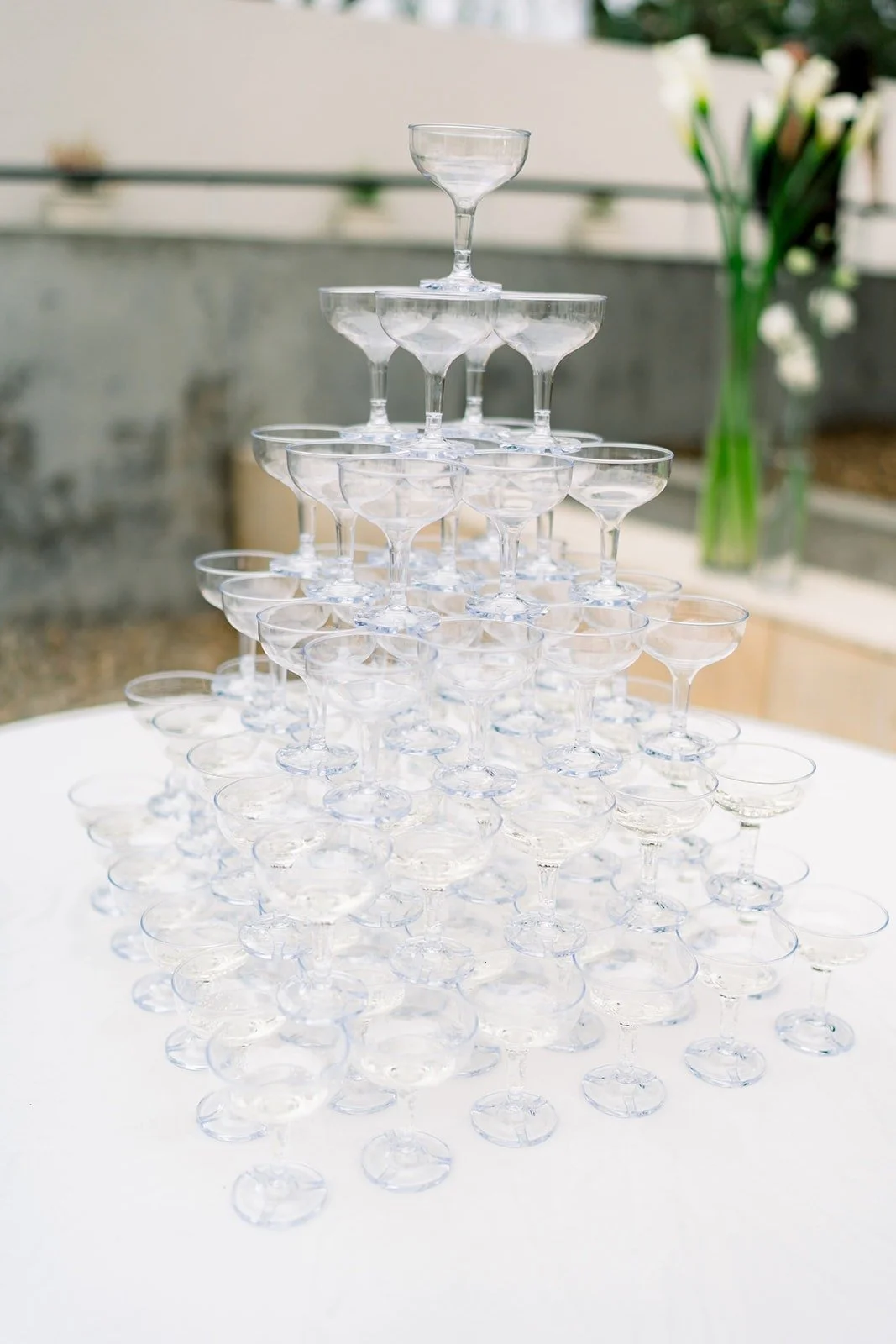 A champagne tower set up on a white table
