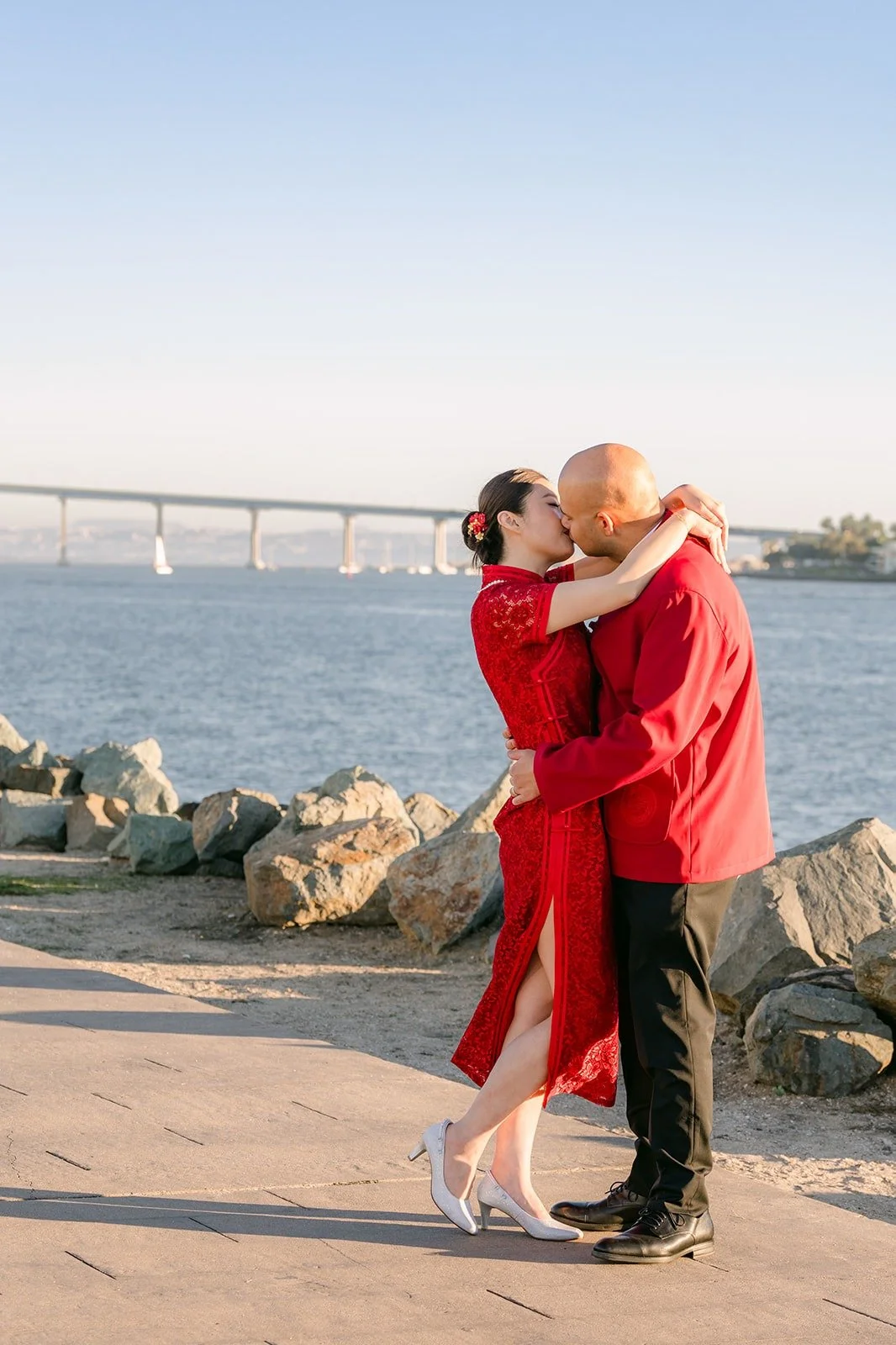 Elisa and Brandon hug with the Coronado Bridge in the distance