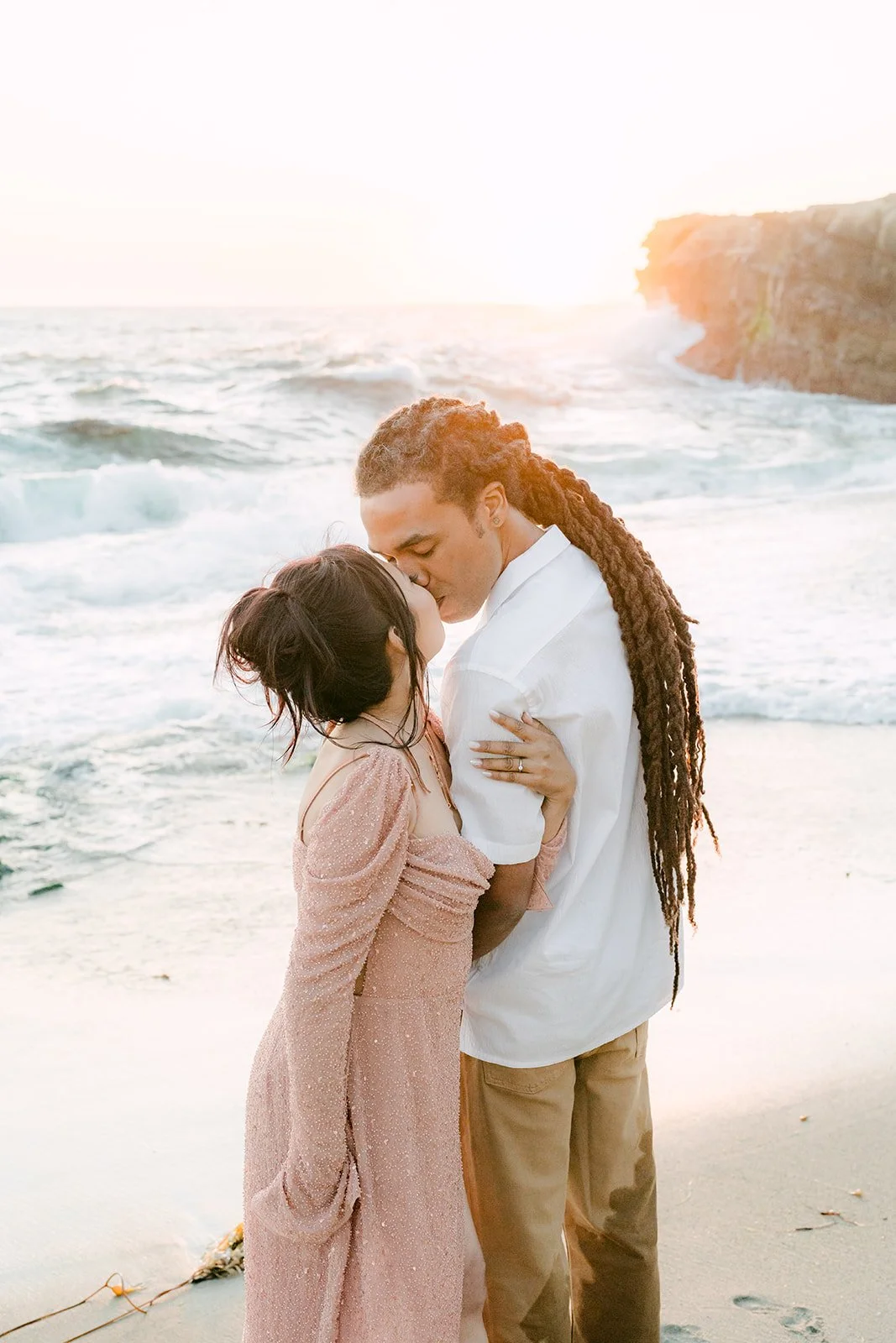 Amy and Michael embracing by the water.