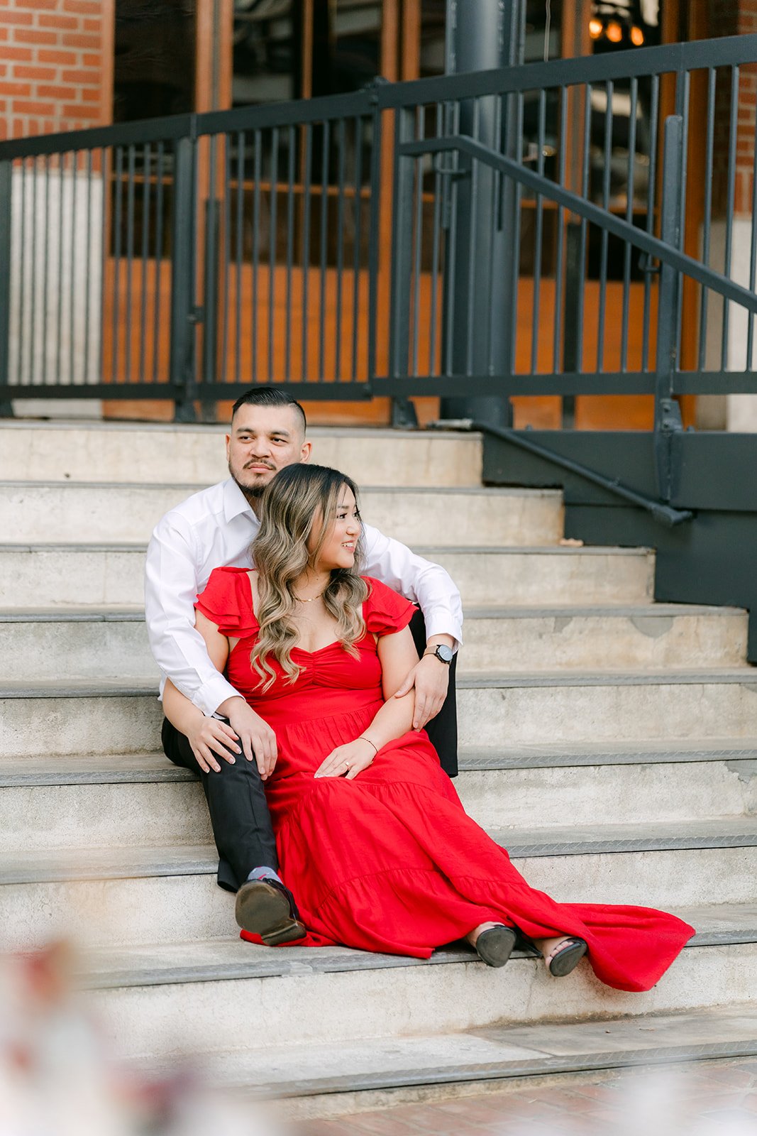 Linh and Ankush seated on wide stone steps in Old Town Pasadena.