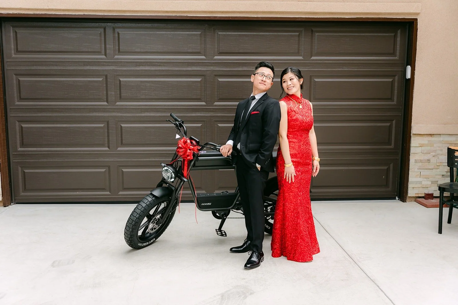 Xuemin and Alex posing with the motorbike outside the garage