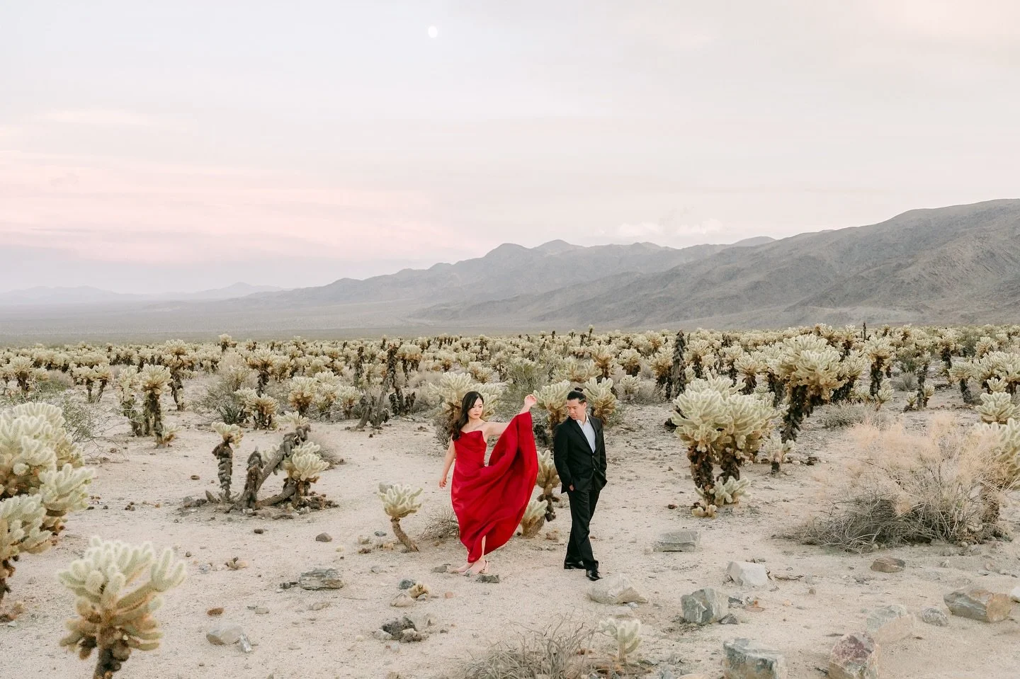 Desert heat, wild hearts ❤️🔥 Chasing love and adventure in Joshua Tree with K&amp;M engagement session &mdash; summer sun, a red dress, and forever on the horizon. 
.
Bride @katektwong Groom @mykol.2 
@trangformation 
.
#joshuatreeengagement #engage