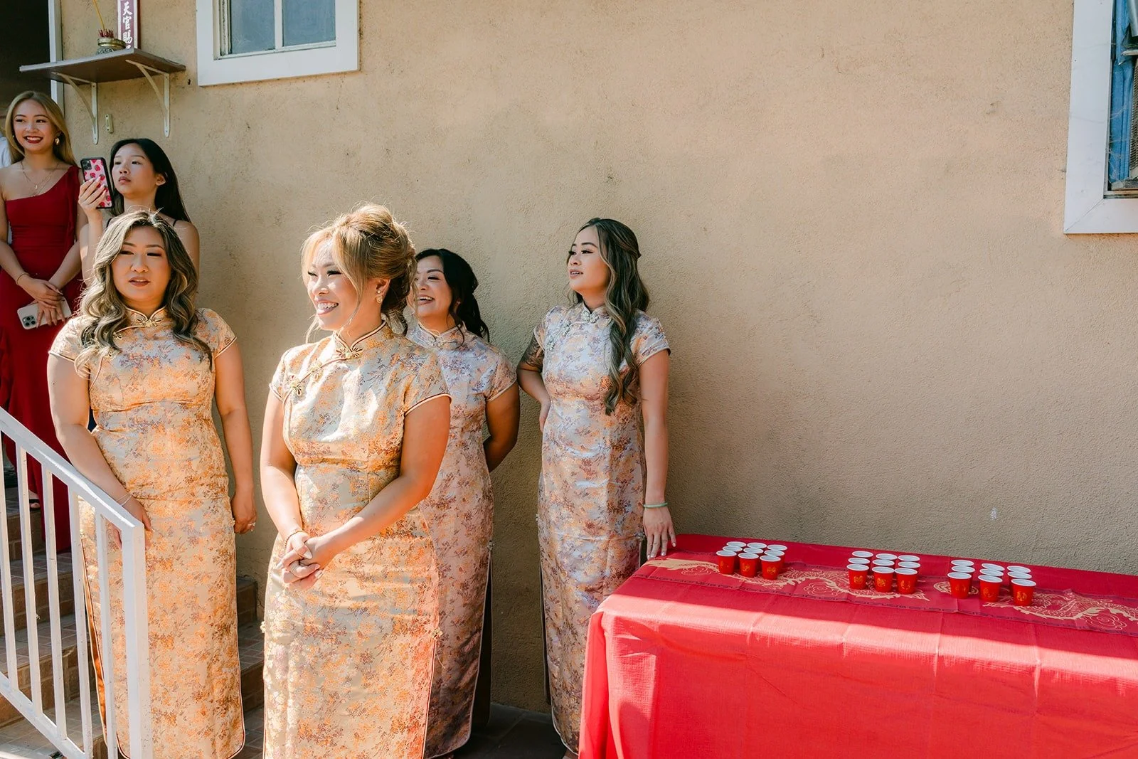 Bridesmaids in gold waiting at the door for the groom