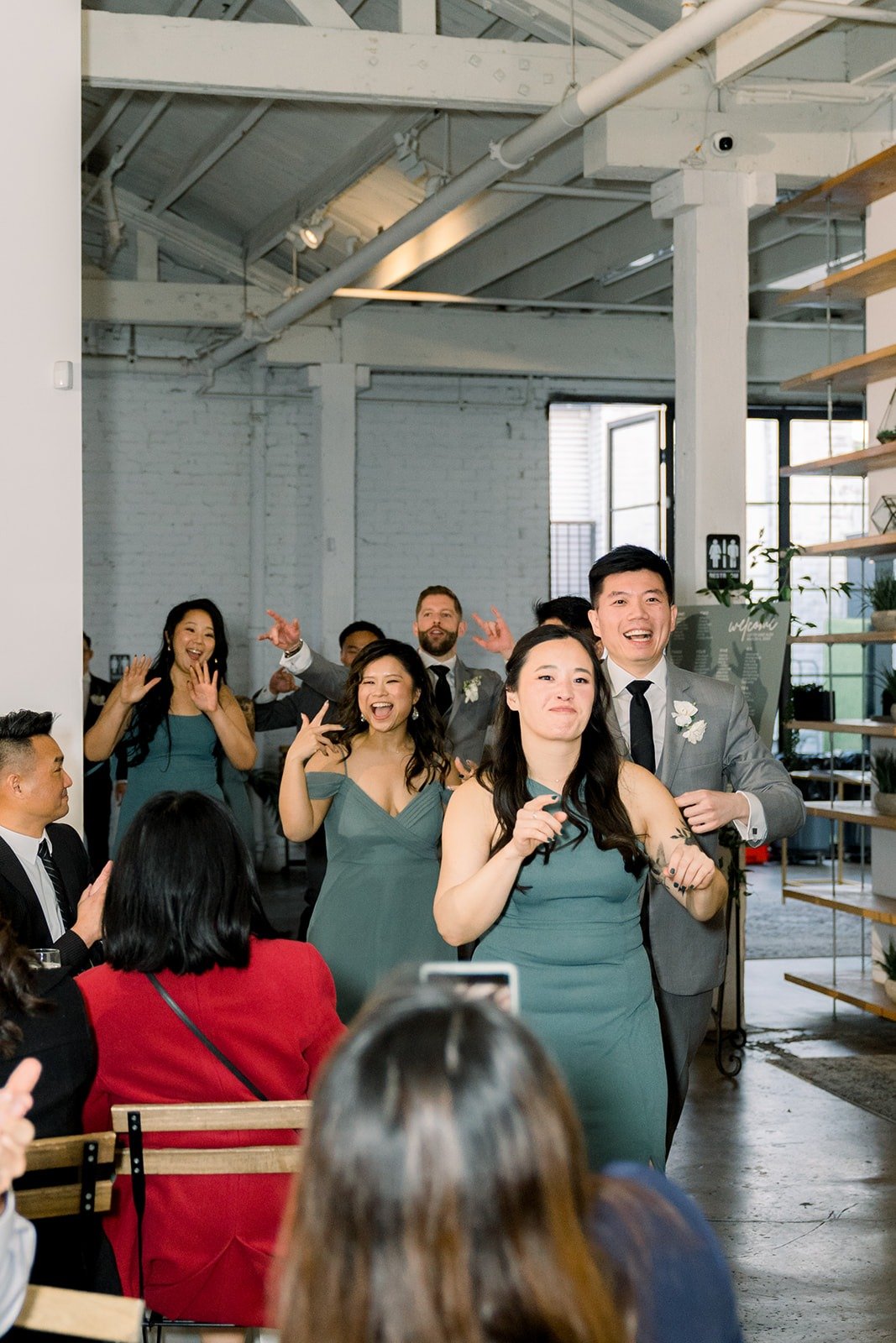 A bridesmaid hypes up the crowd during the grand entrance