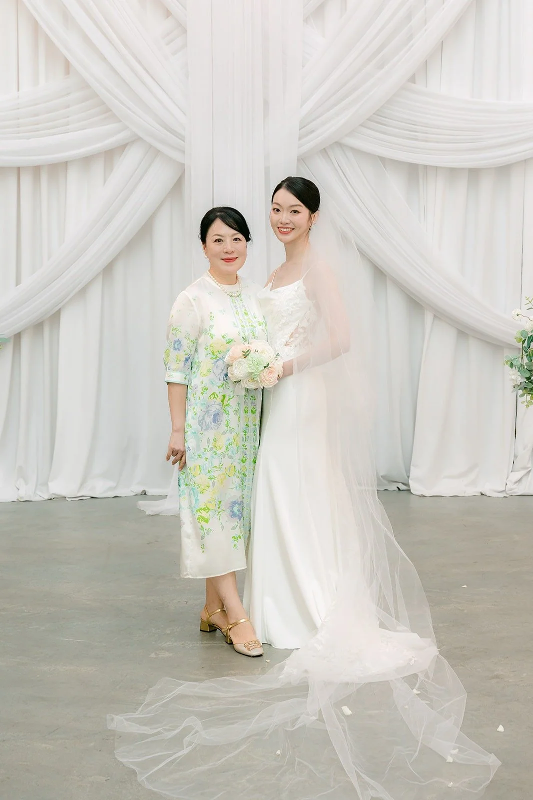 Tin with a family member in front of the chapel drapes